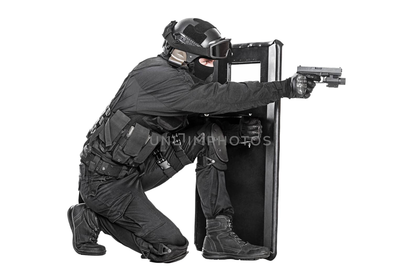 Spec ops police officer SWAT with ballistic shield studio shot