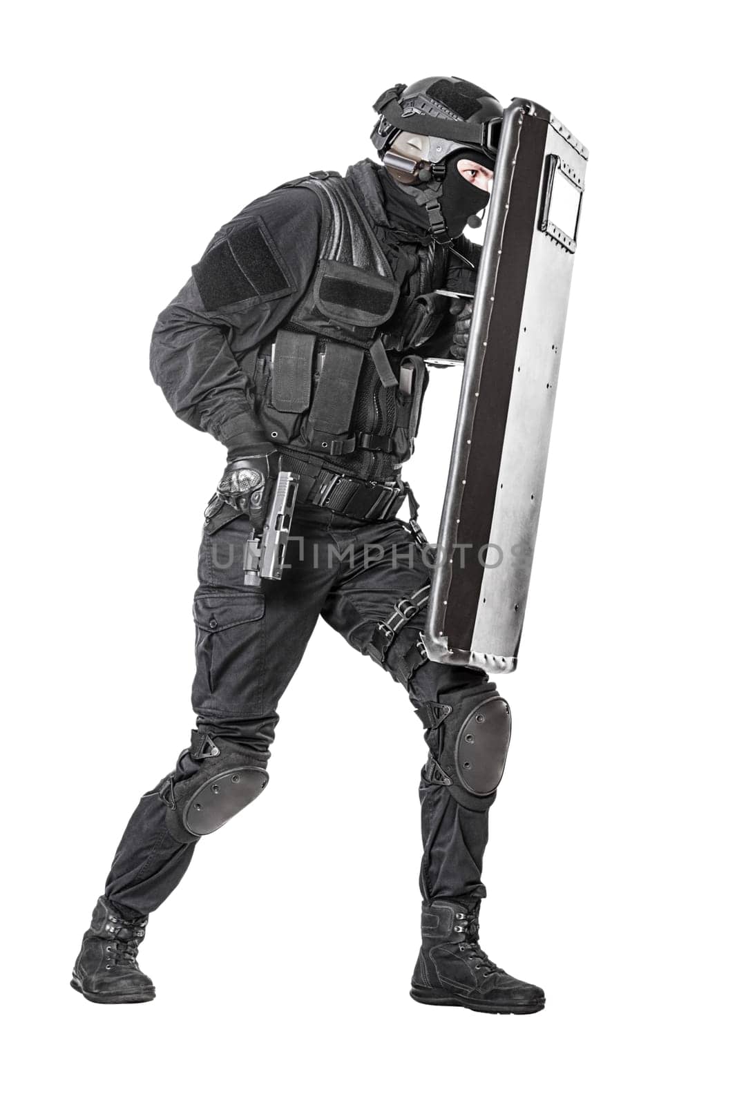 Spec ops police officer SWAT with ballistic shield studio shot