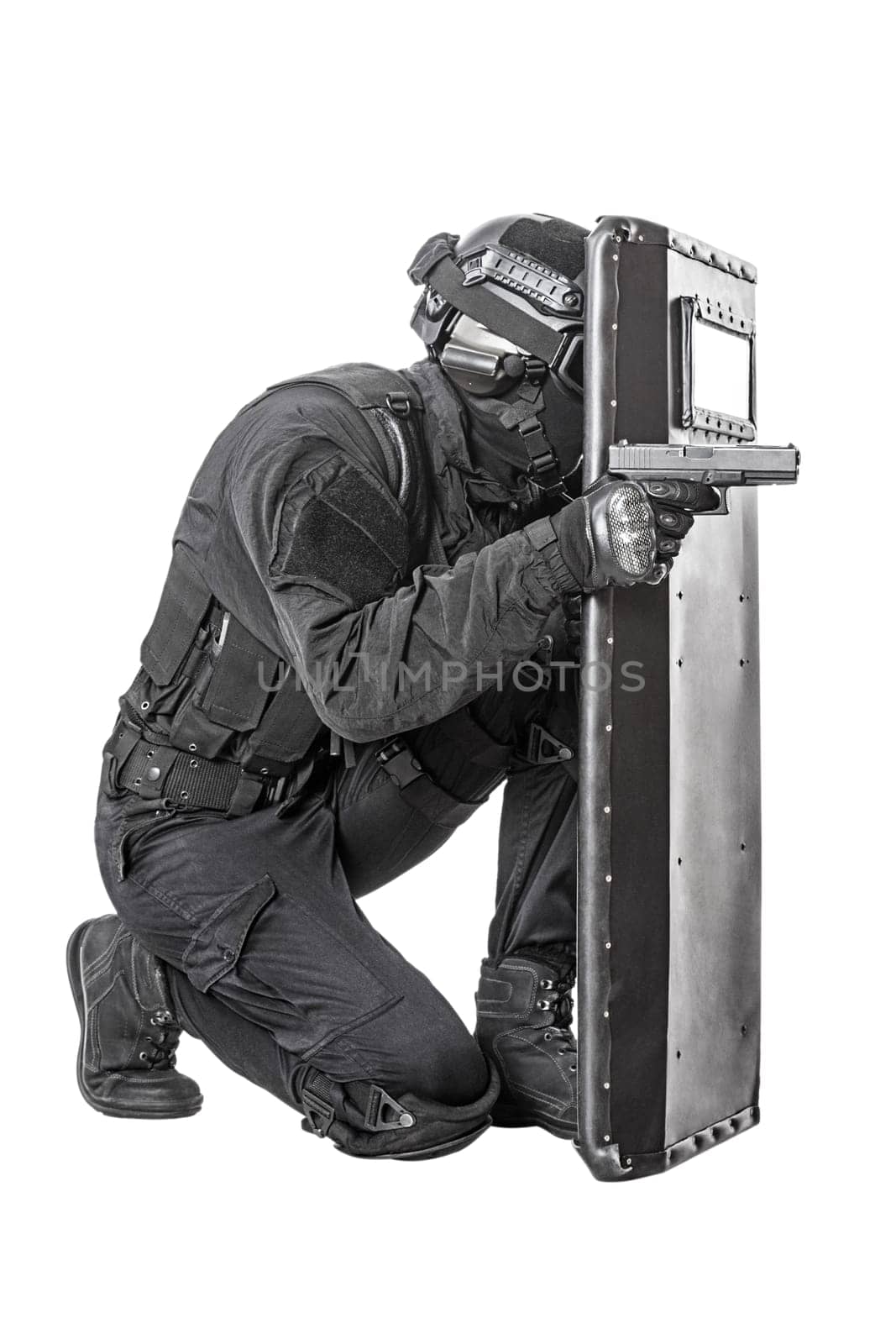Spec ops police officer SWAT with ballistic shield studio shot