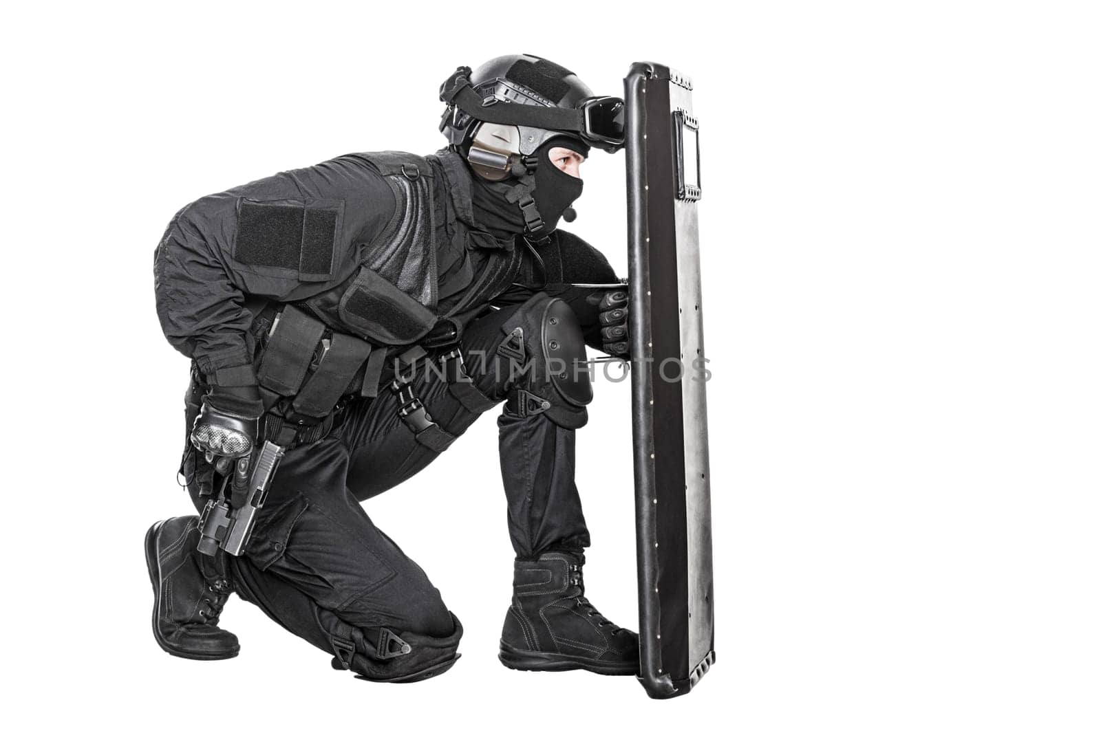 Spec ops police officer SWAT with ballistic shield studio shot