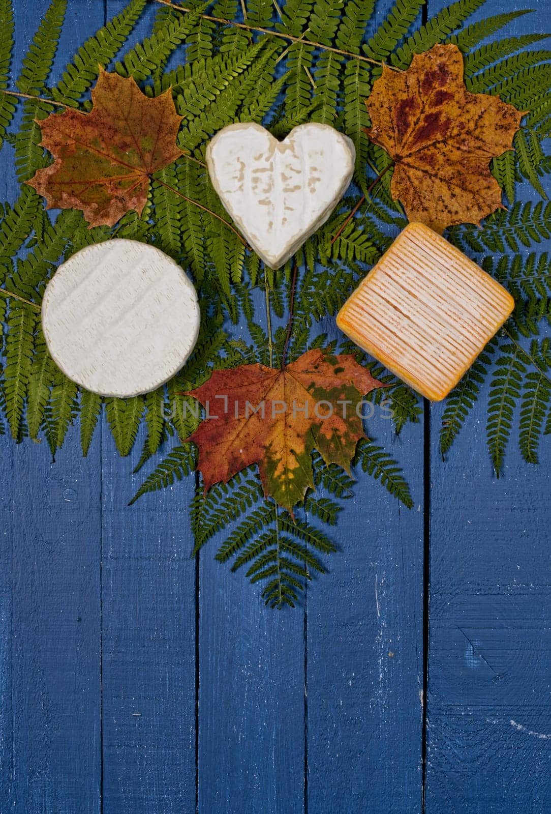 different french cheeses on blue wooden table