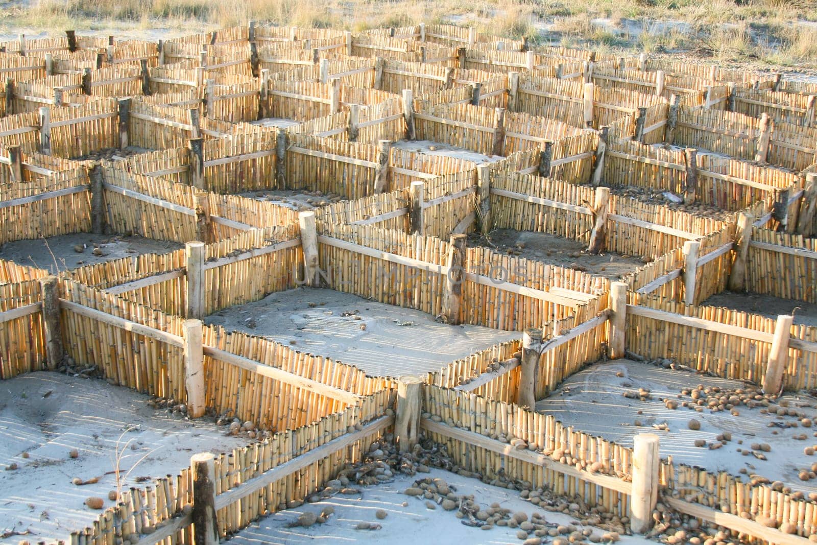 Barrier for sand. Useful against shoreline erosion