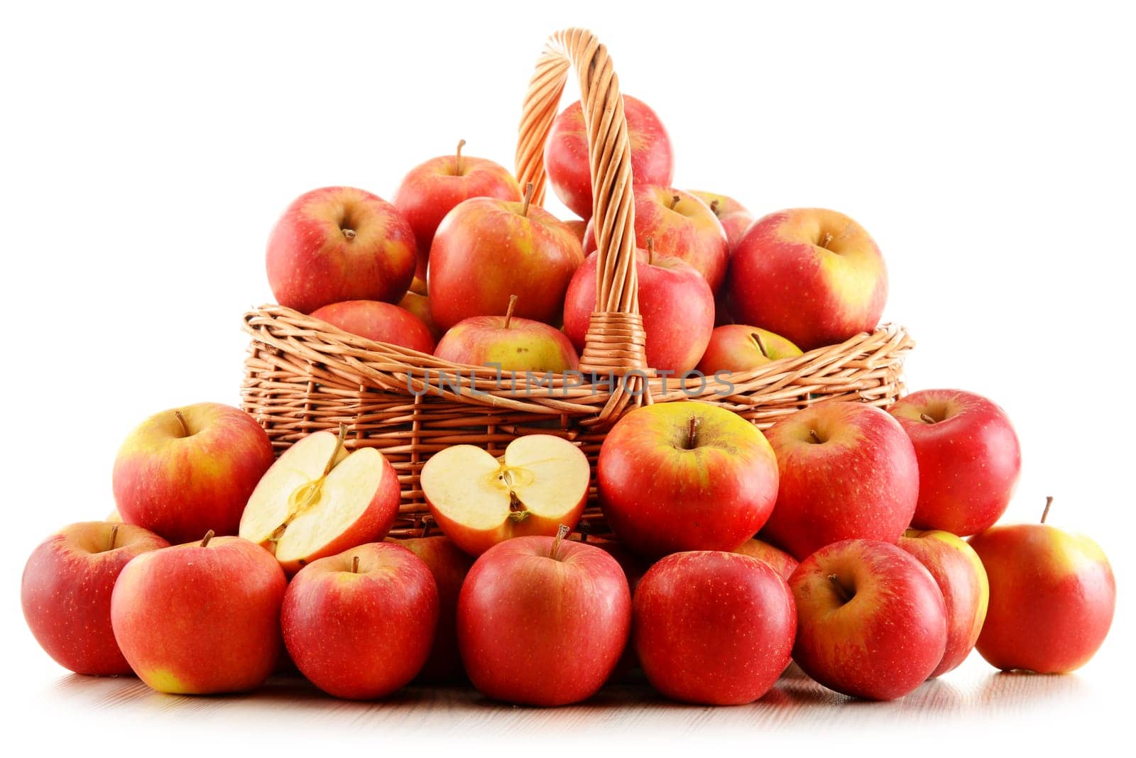 Apples in wicker basket isolated on white background