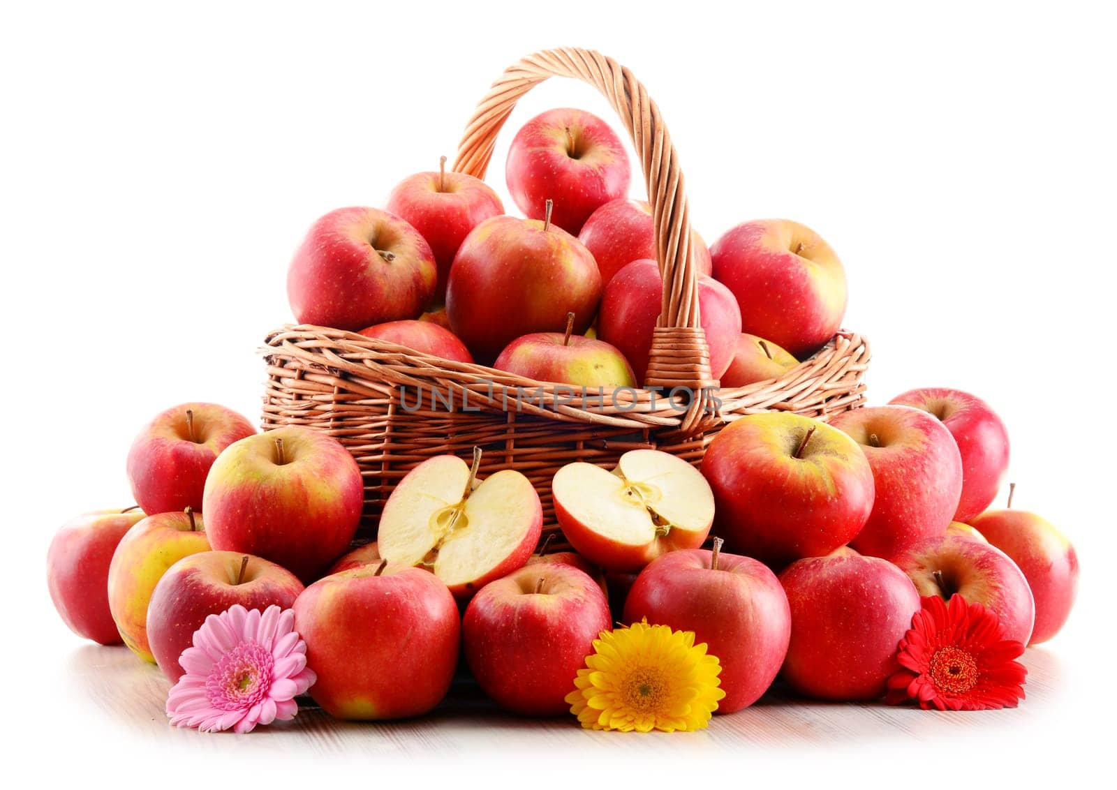 Apples in wicker basket isolated on white background