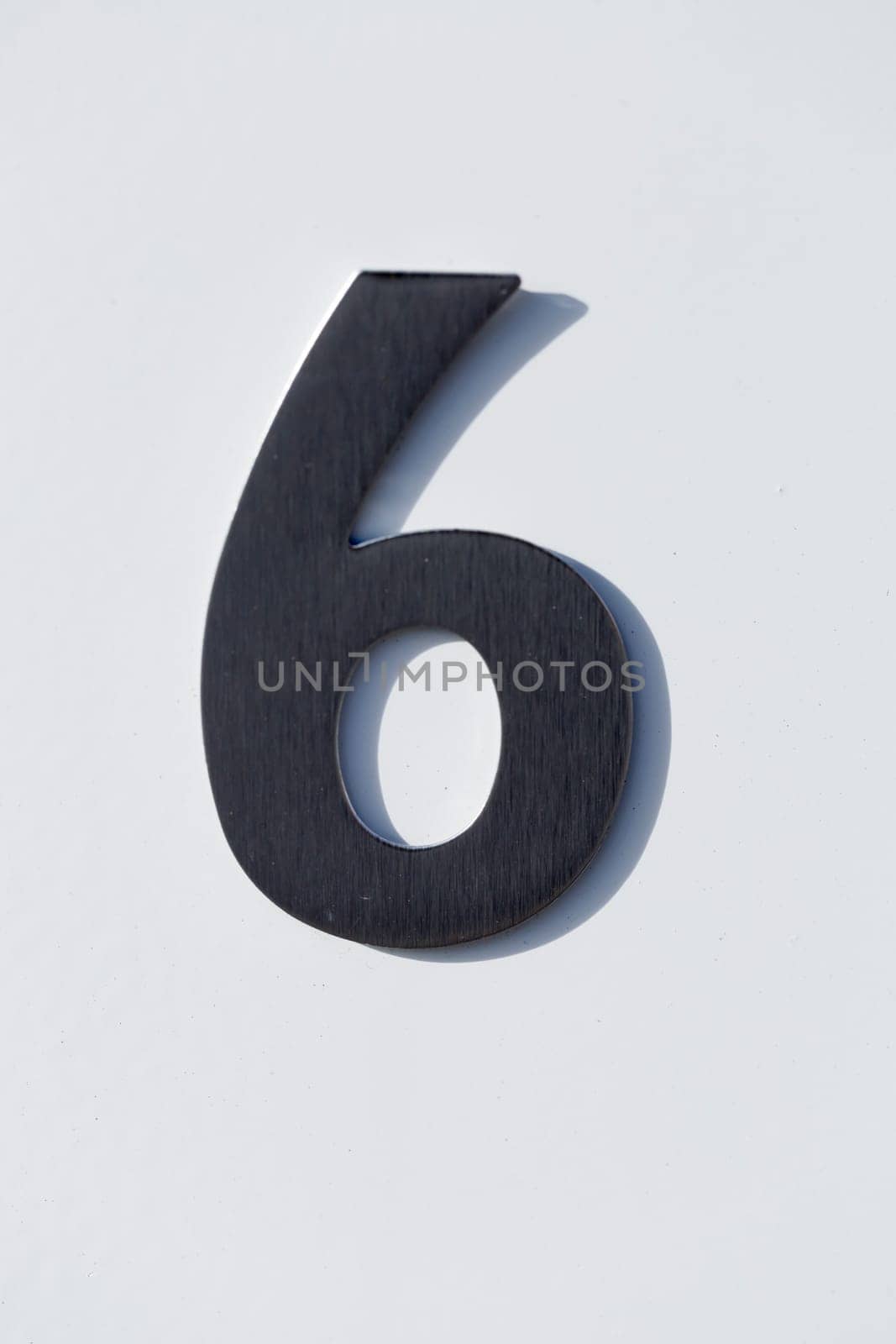 Number 6 on a Post Box with white backgound.