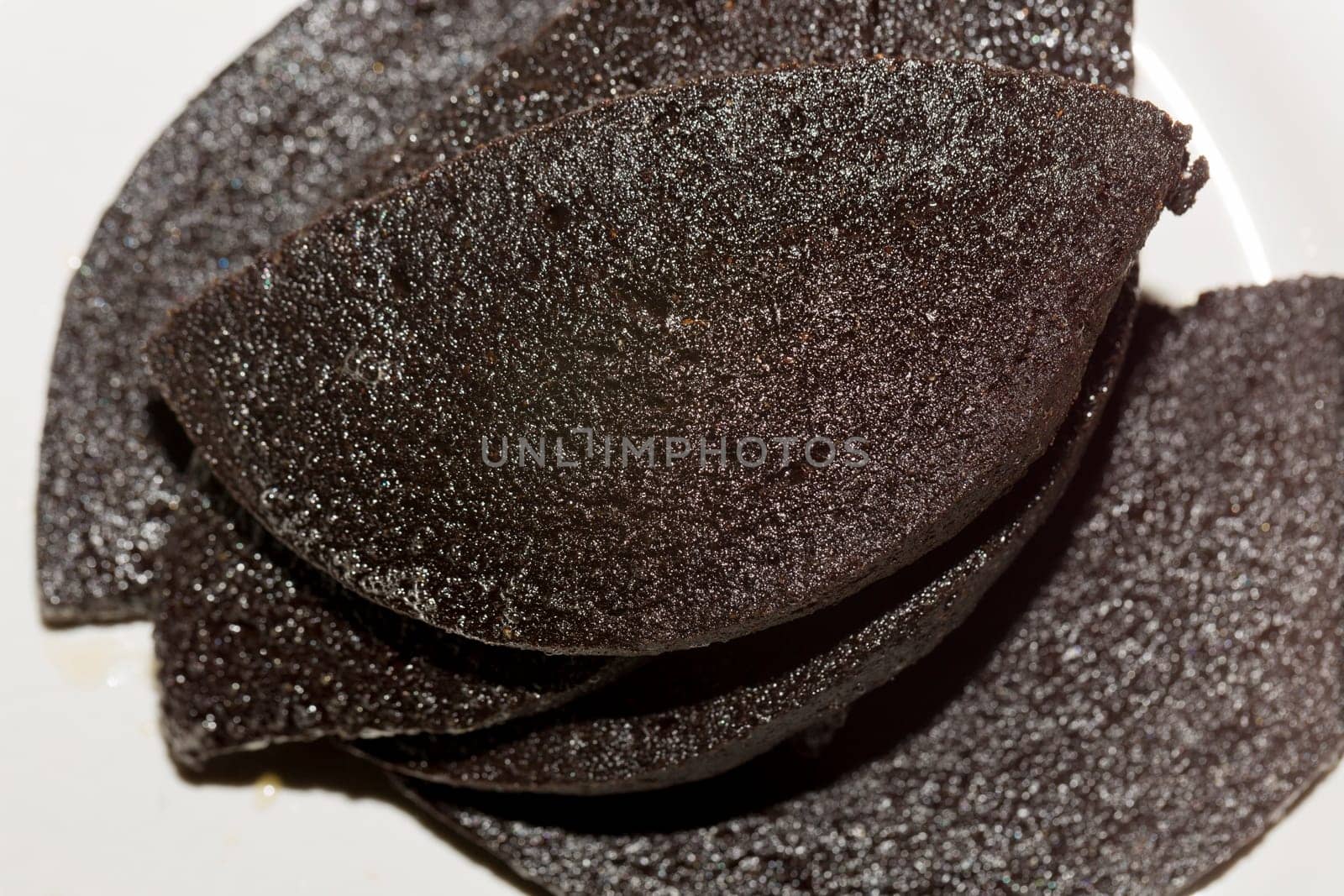Swedish Blood Pudding on White Plate glisseing of butter.
