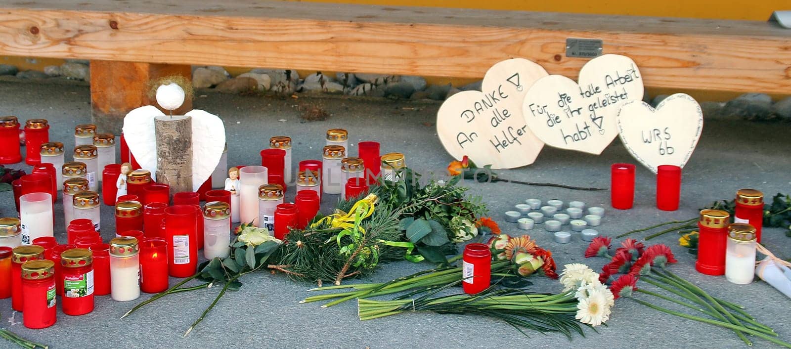 Candles,flowers and a few small farewell lines commemorate the 14 dead of the Titisee-Neustadt fire disaster in front of the workshop for the disabled
