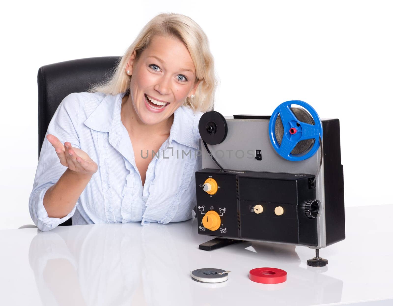 Blonde woman presents an old film projector