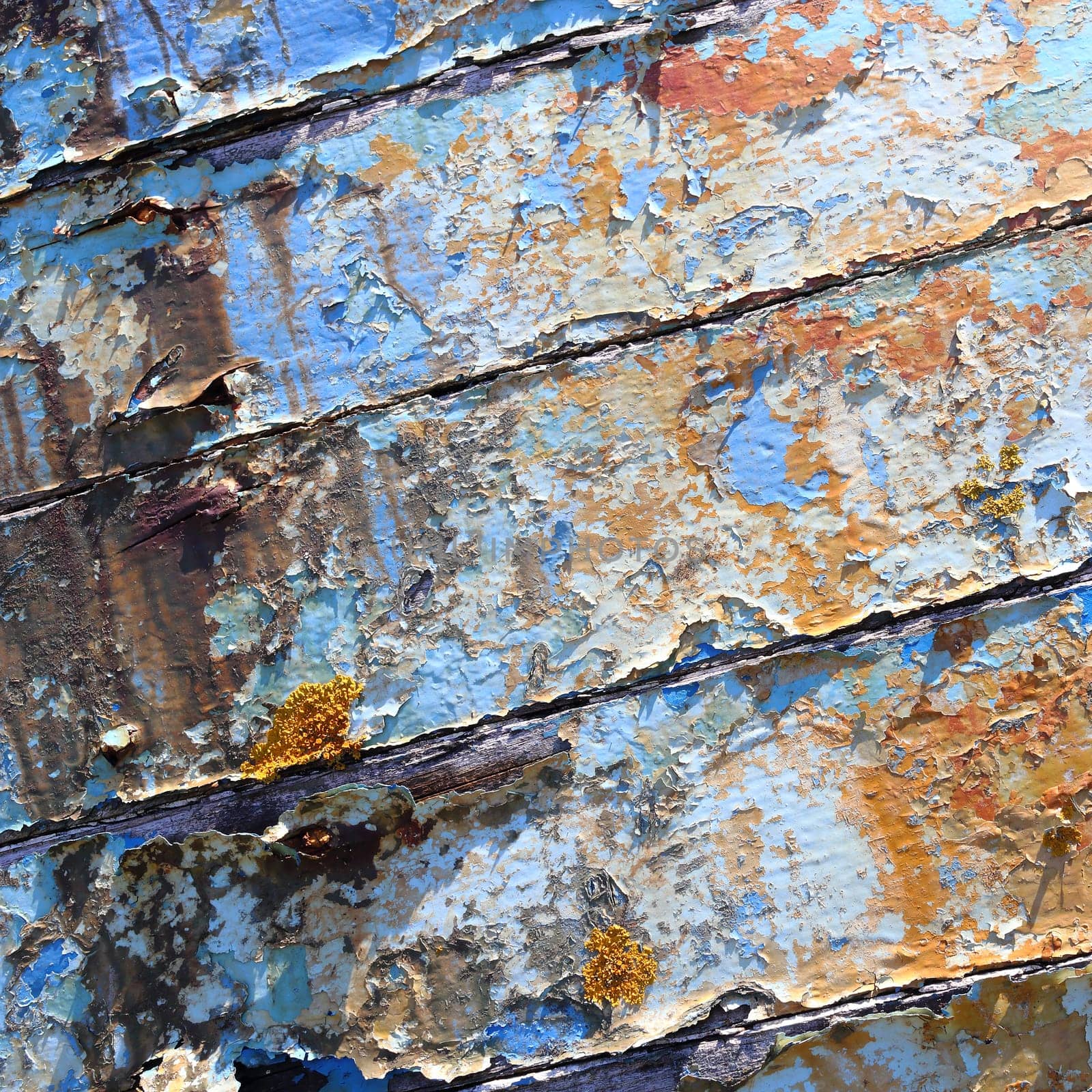 Boards of old boat with peeling paint background texture