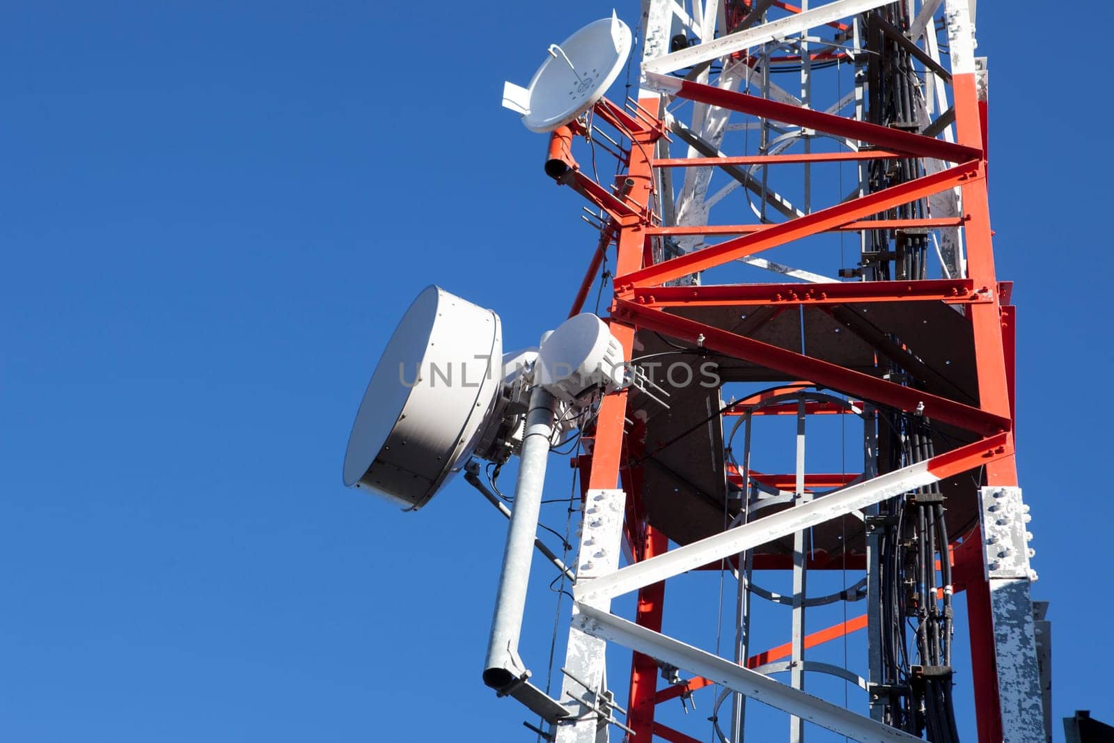 Mobile phone Telecommunication Radio antenna Tower over blue sky