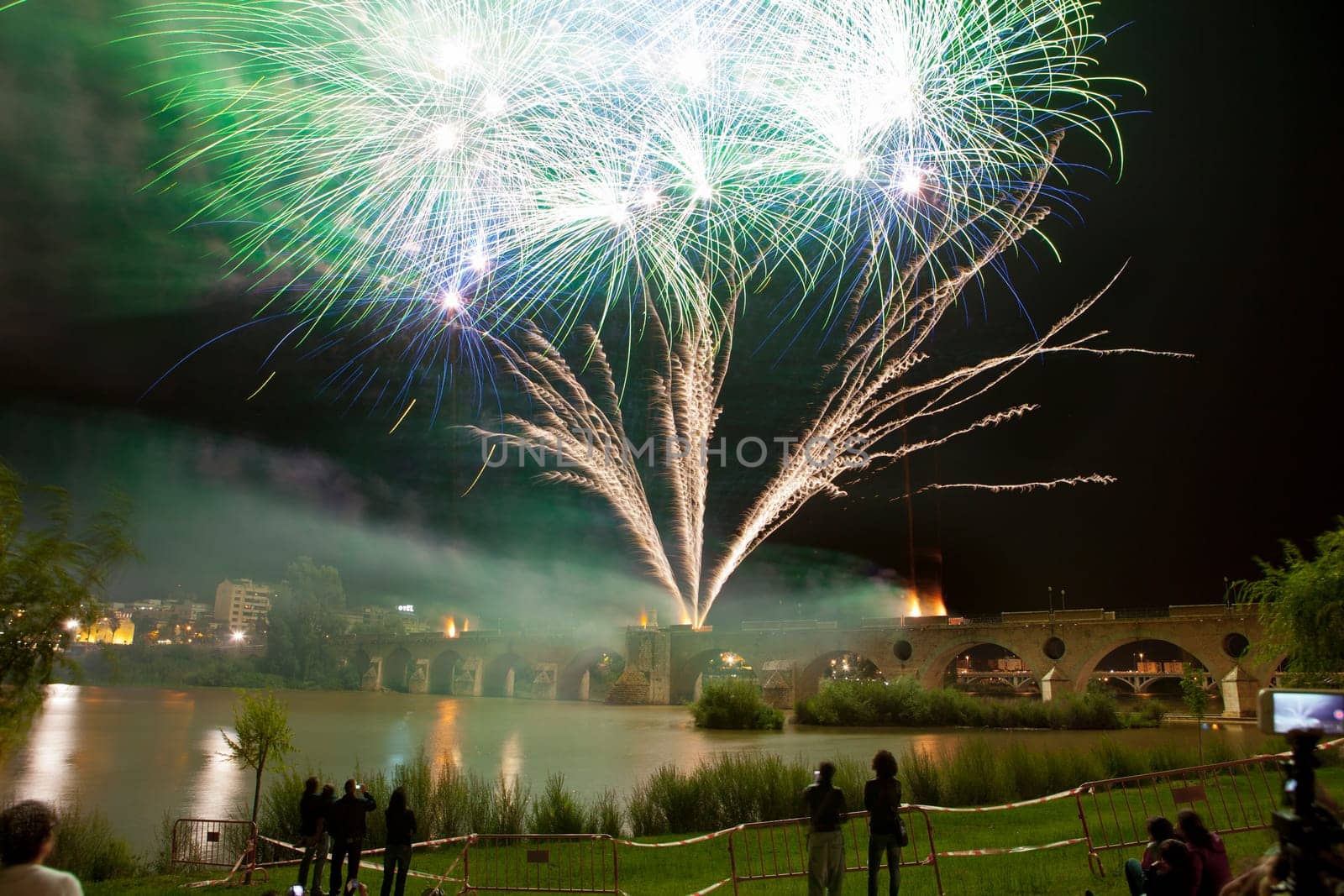 Colorful fireworks shot from Puente de Palmas bridge at Badajoz, Spain, during the San Juan festivity night