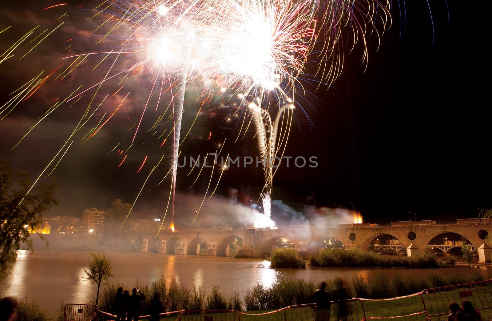 Colorful fireworks shot from Puente de Palmas bridge at Badajoz, Spain, during the San Juan festivity night