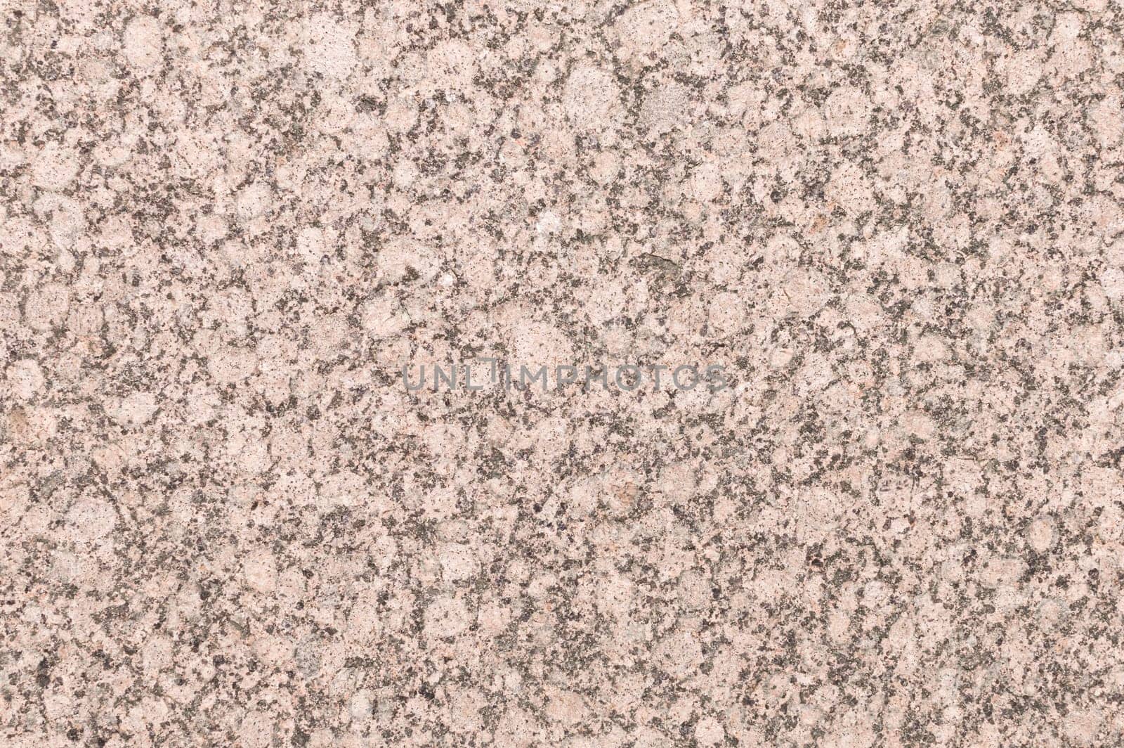 Mineral background with red or pink granite texture cut and unpolished surface of decorative trim stone