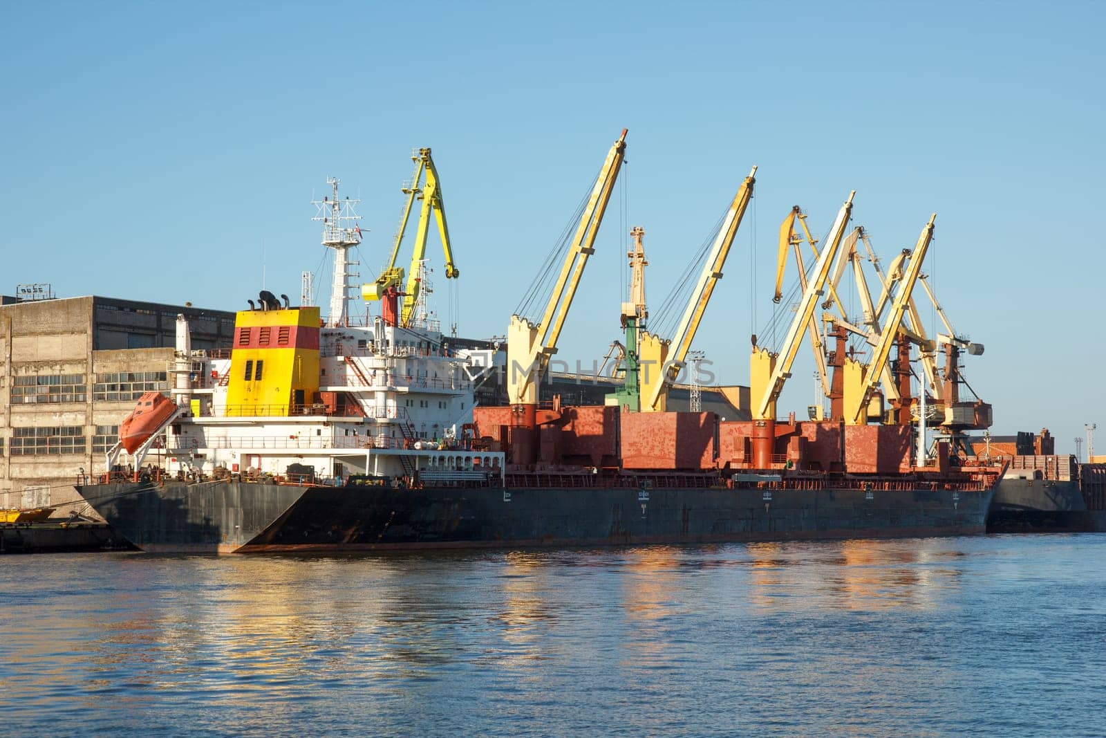 A coal ship docked in a harbor