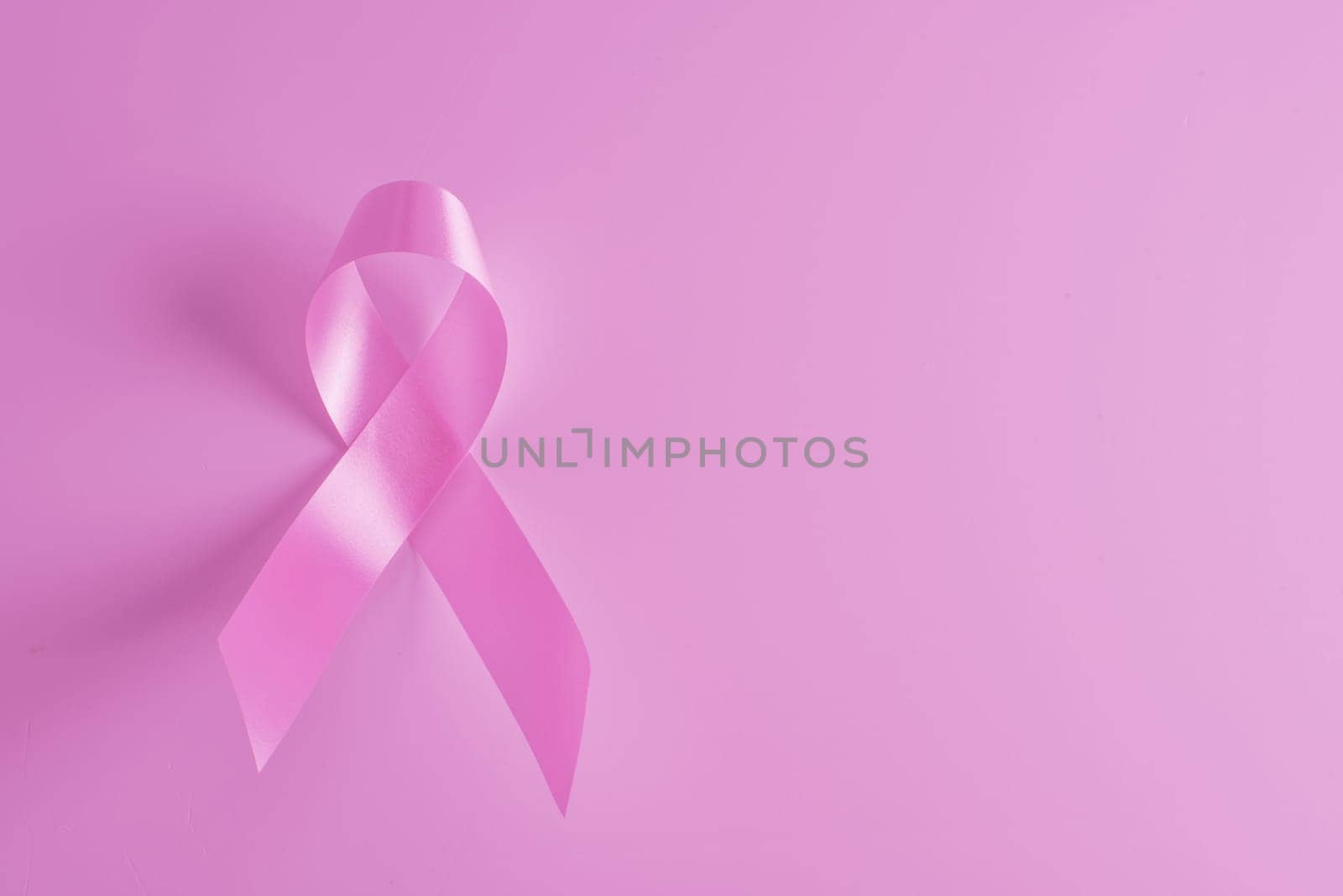Breast cancer awareness pink ribbon and background. Ideal for social media campaign or website.