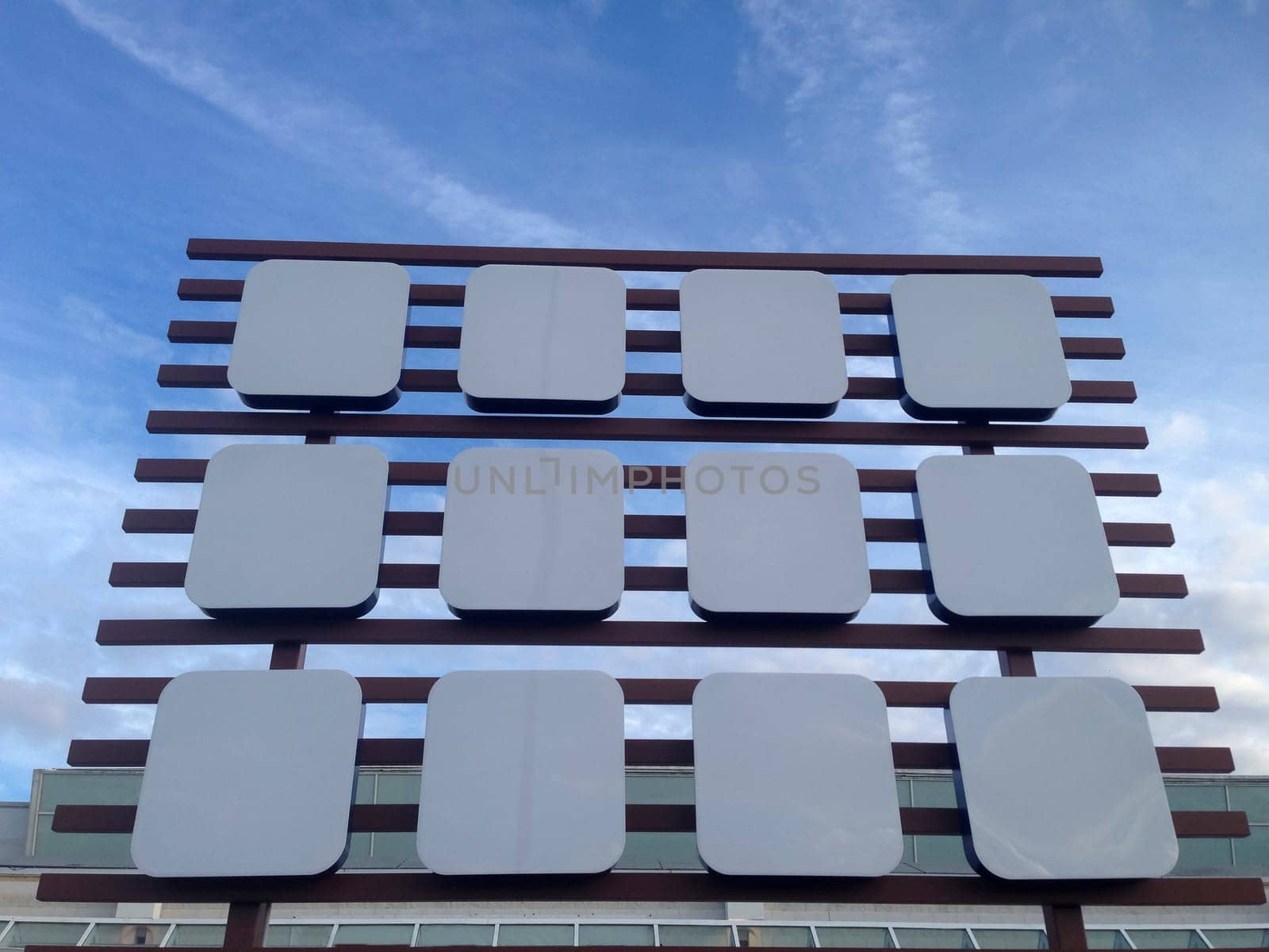 Empty big billboard at shopping mall, isolated over blue sky
