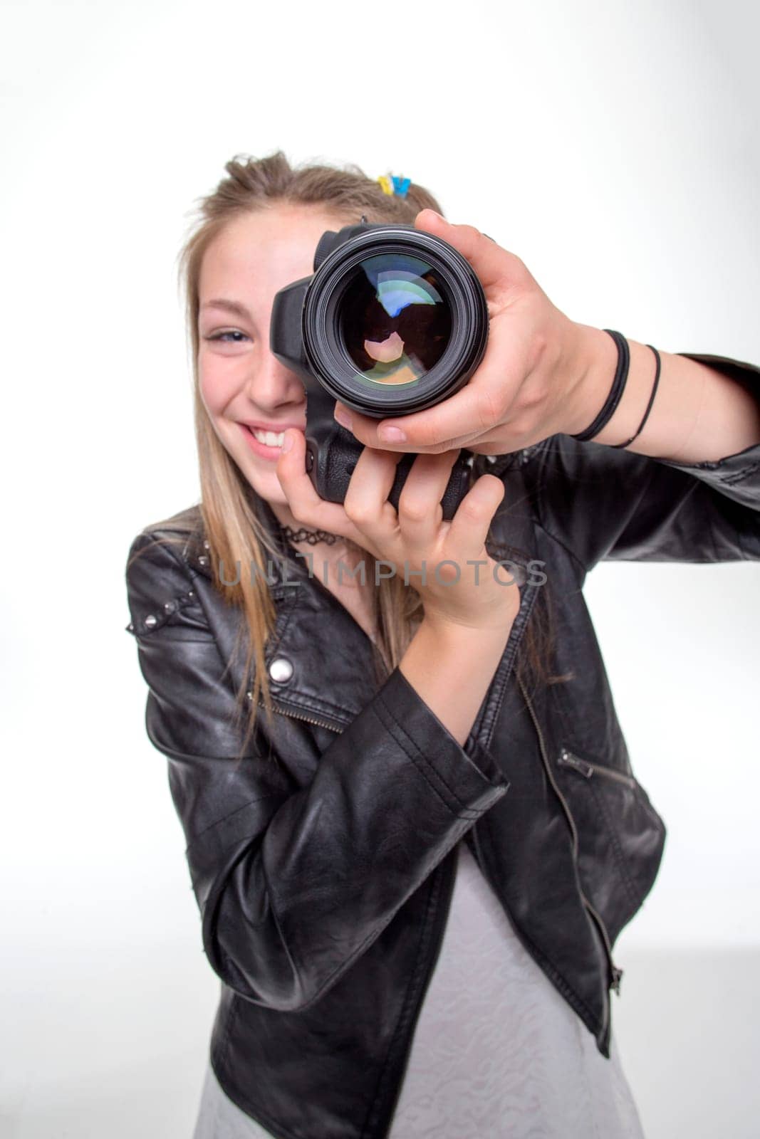Teenage girl taking a photo with a camera