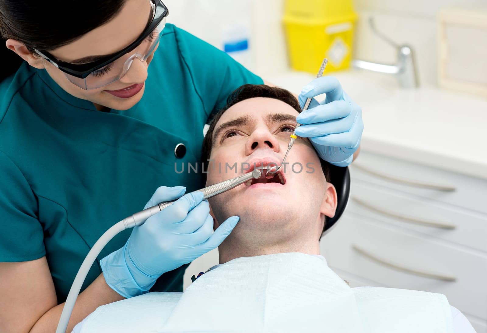 Image of male patient examining by dentist