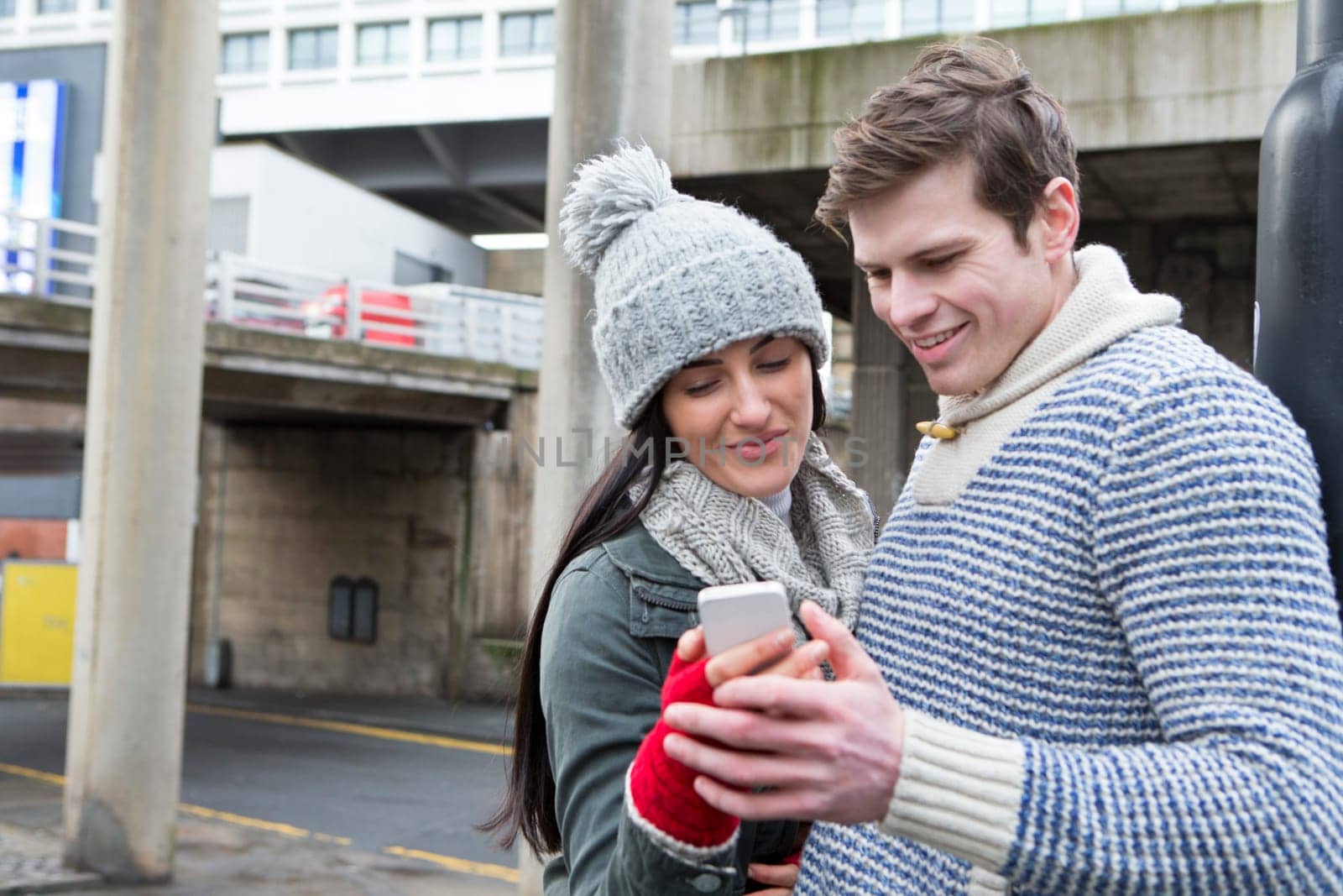 Young couple taking a selfie on a smartphone in the city