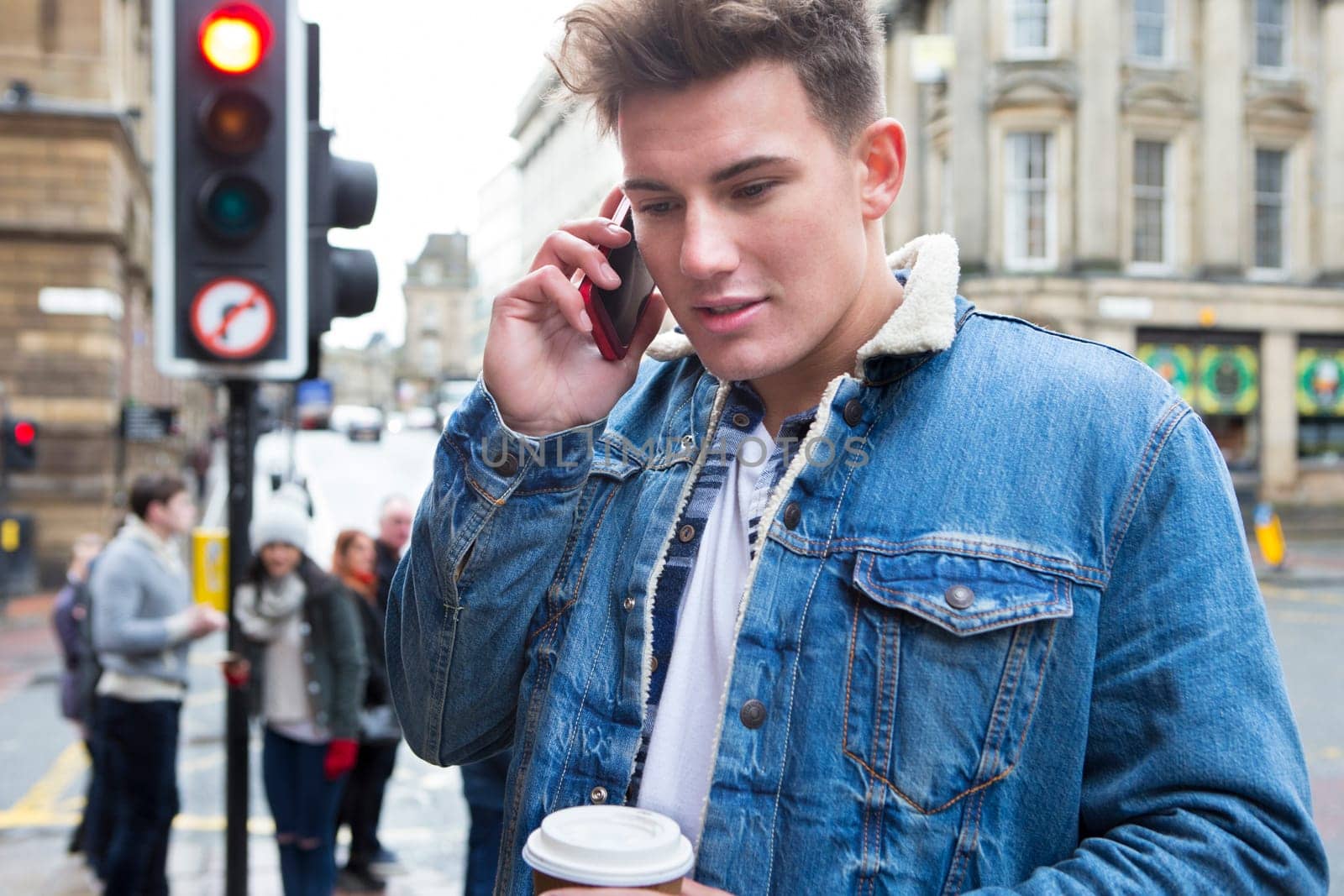 Close up of a young man on the phone in the city