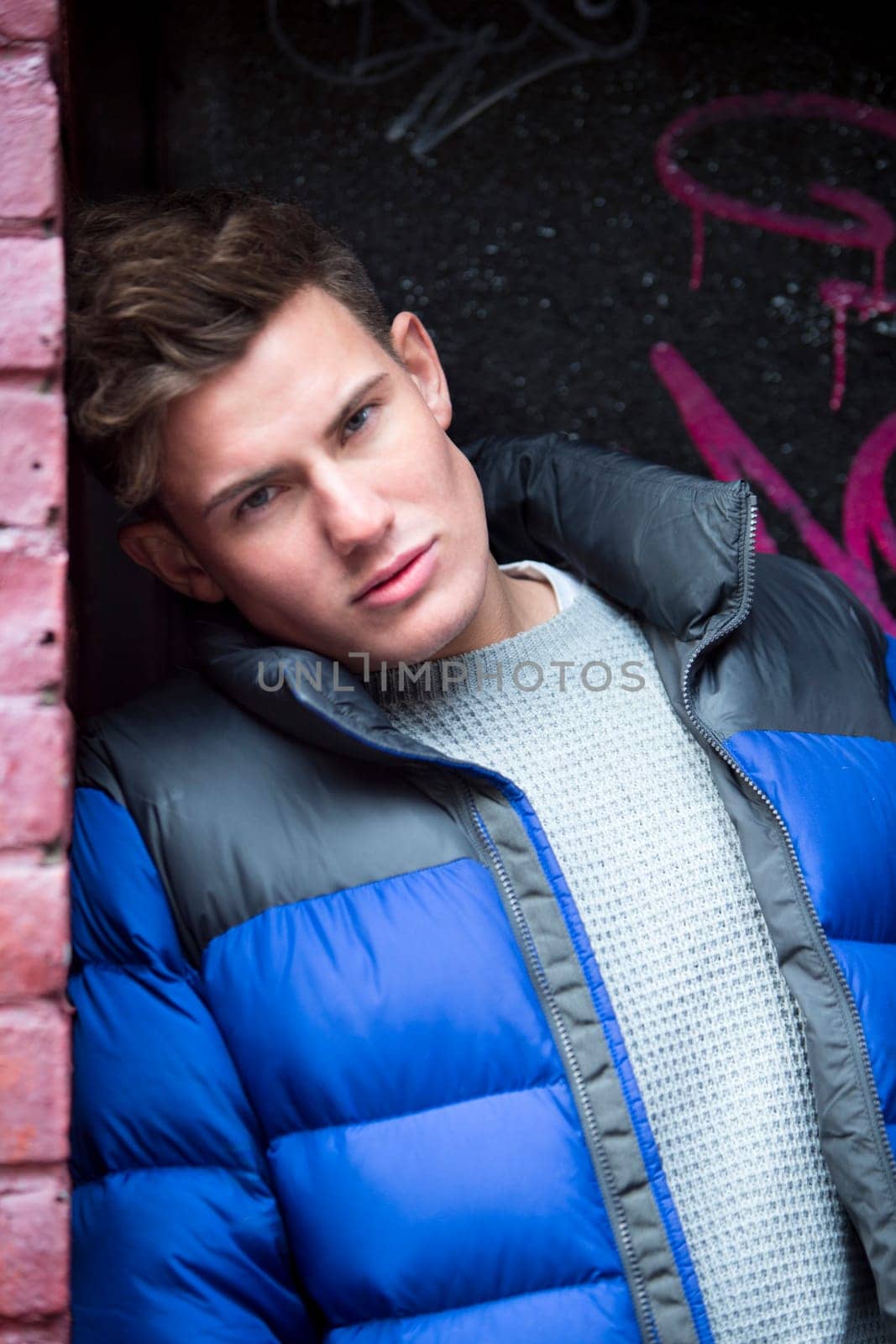 Portrait of an attractive, young man against an urban background in the city