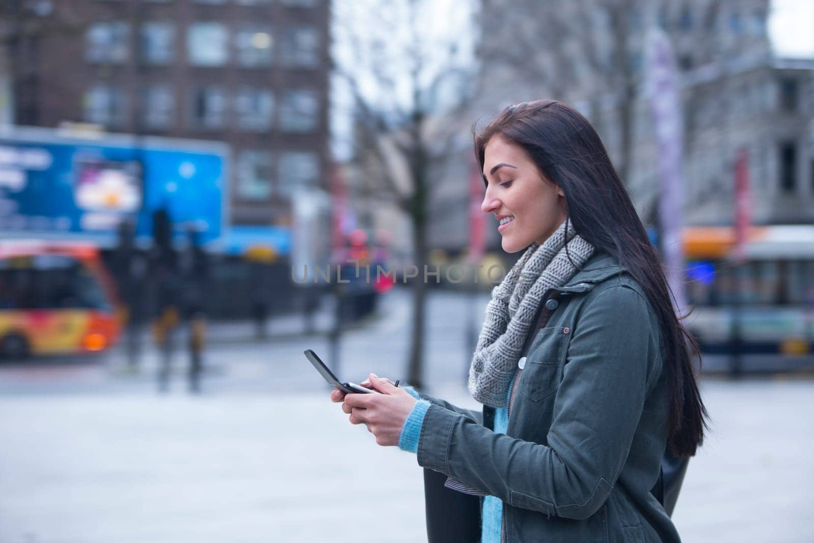 Young woman in the city with a smart phone.
