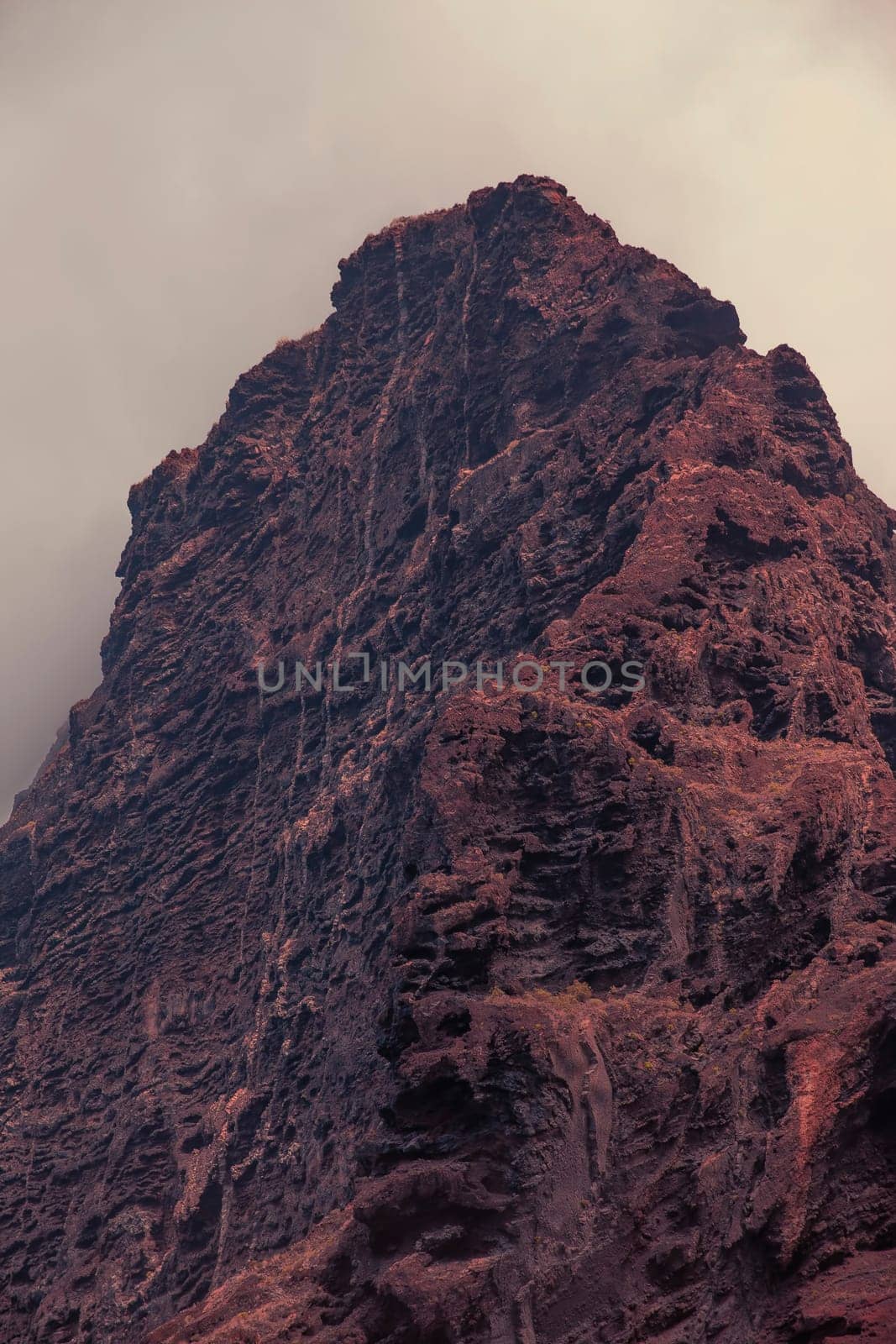 Dramatic mountains sinking in dusk clouds in red planet Mars