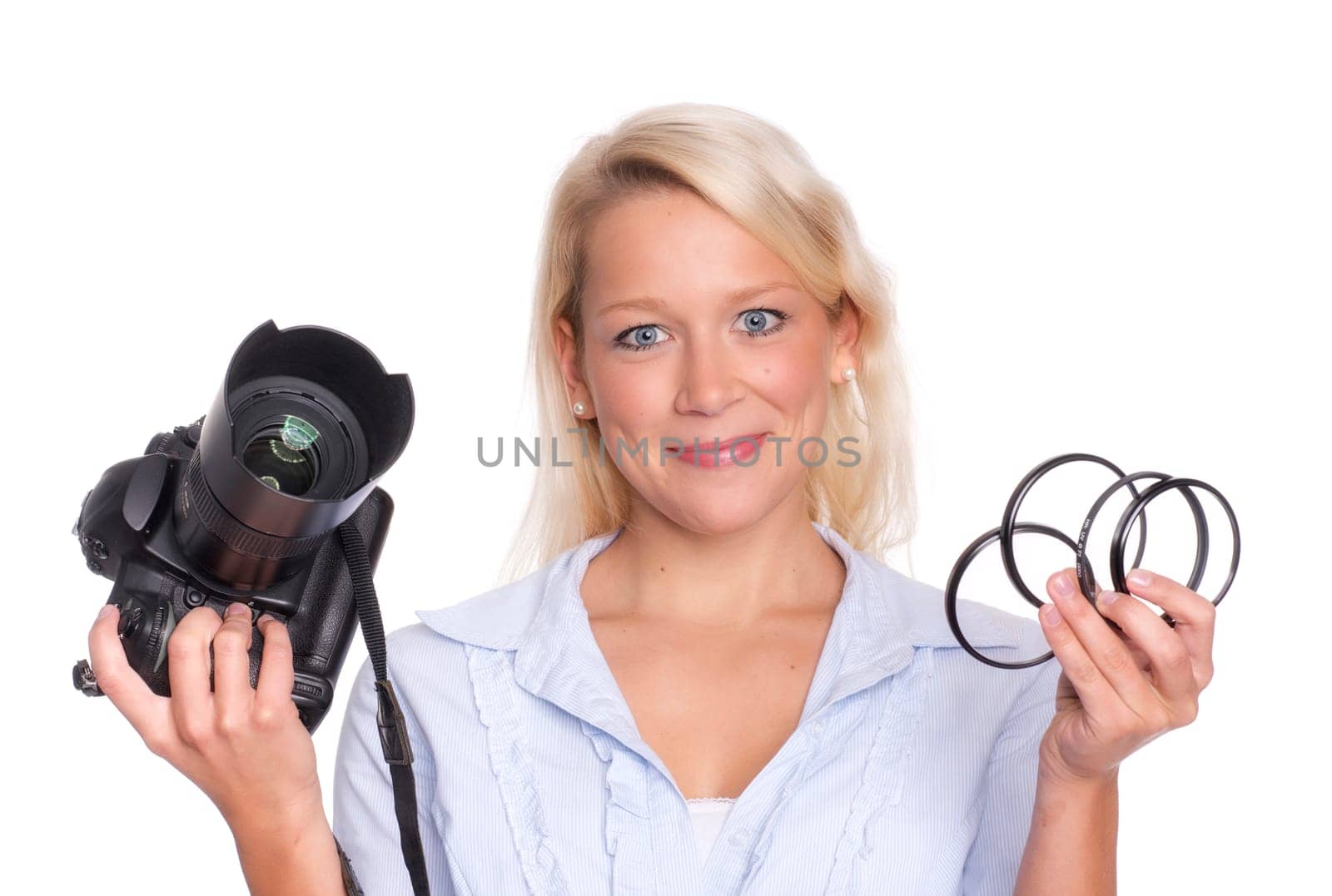 Photographer holds a camera and a few photo filters in her hand