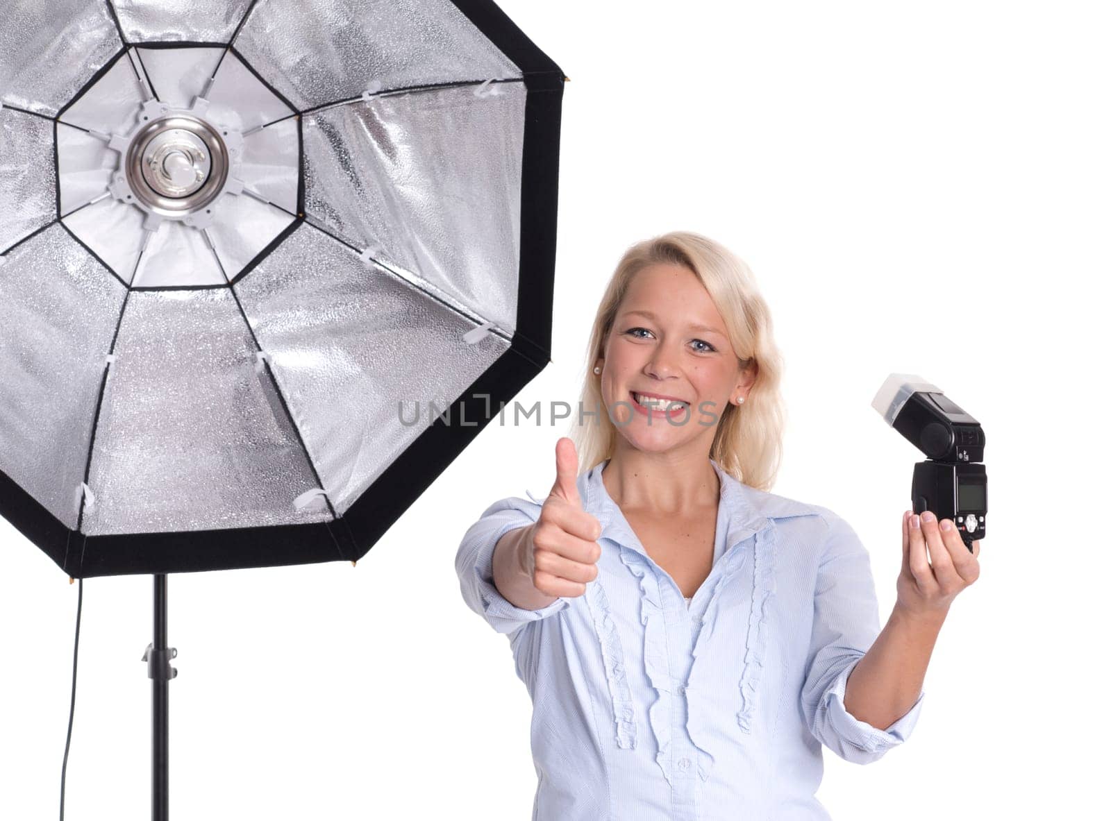 Photographer with studio flash and flash shows thumbs up