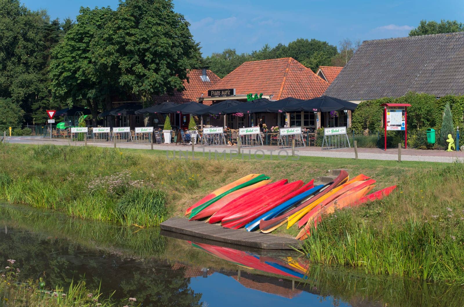 colorful canoes waiting along a canal for tourists