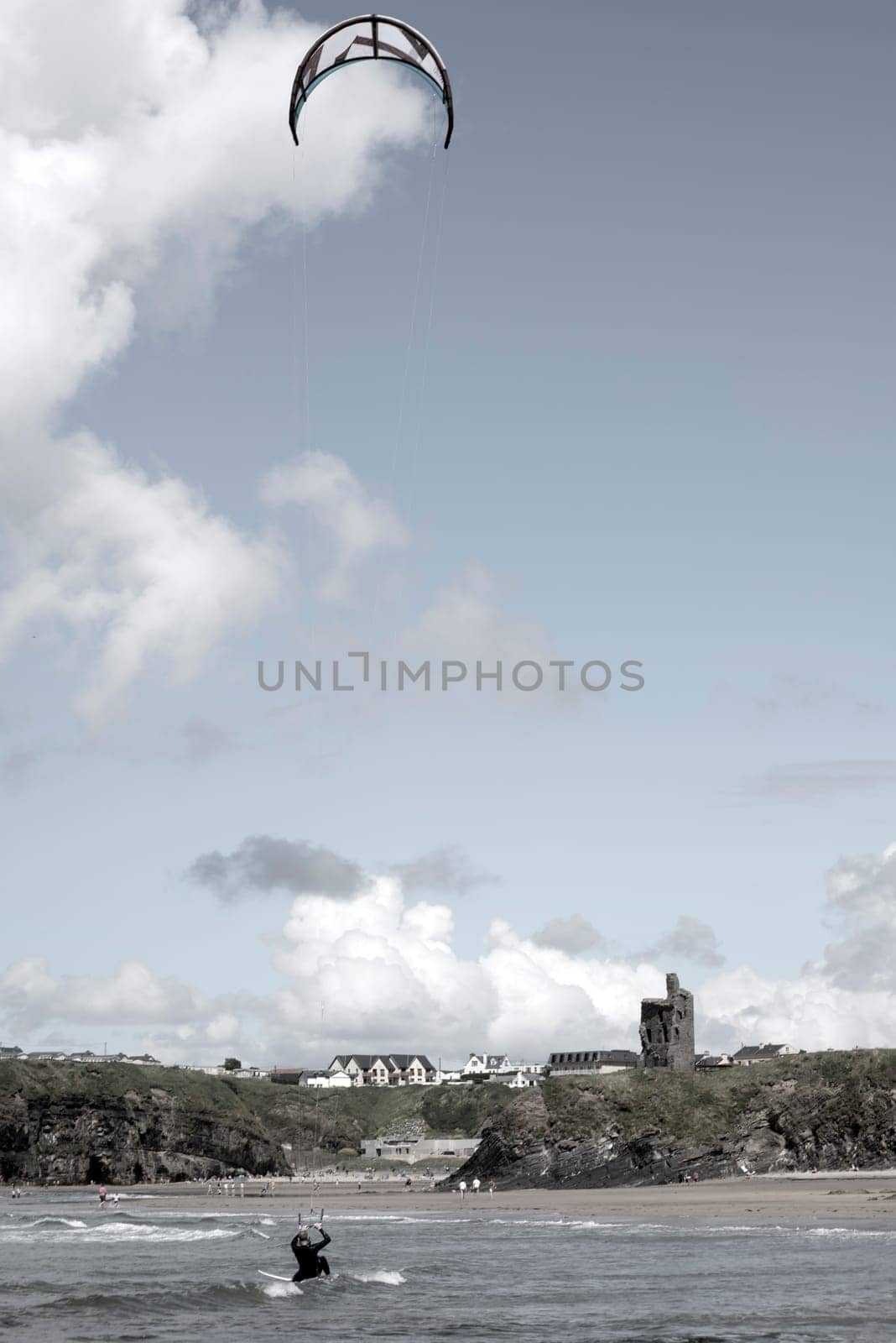 lone kite surfer fighting the waves at ballybunion beach on the wild atlantic way