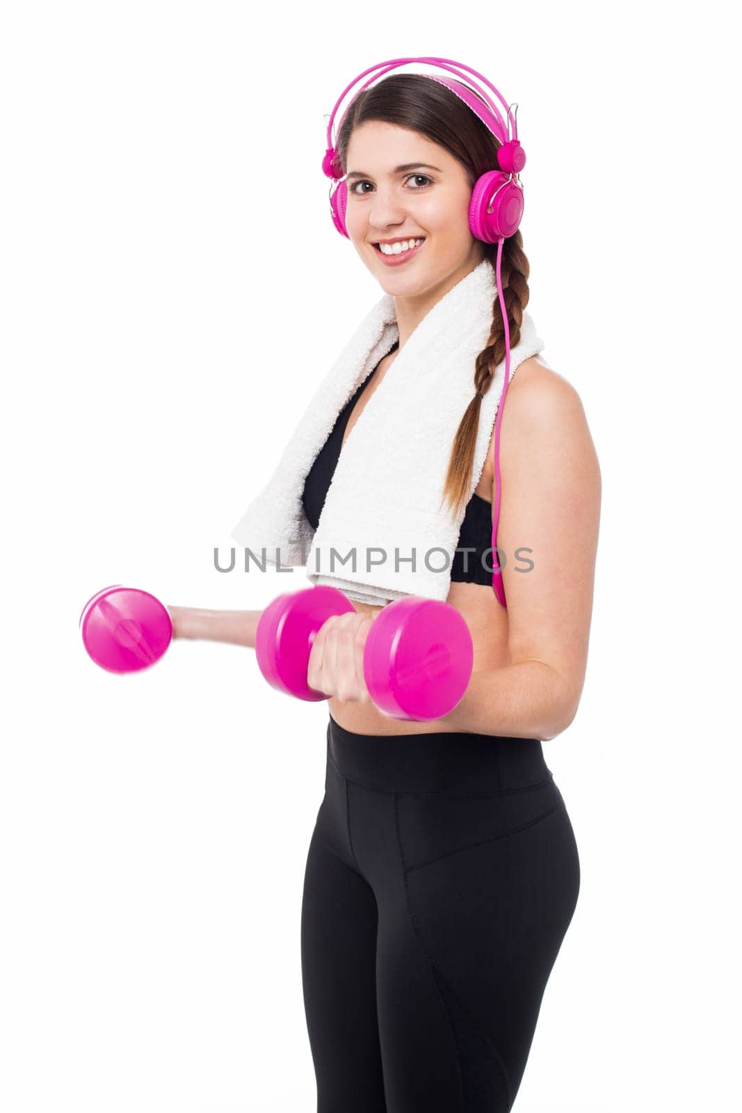 Young trainer working out, tuned into music.