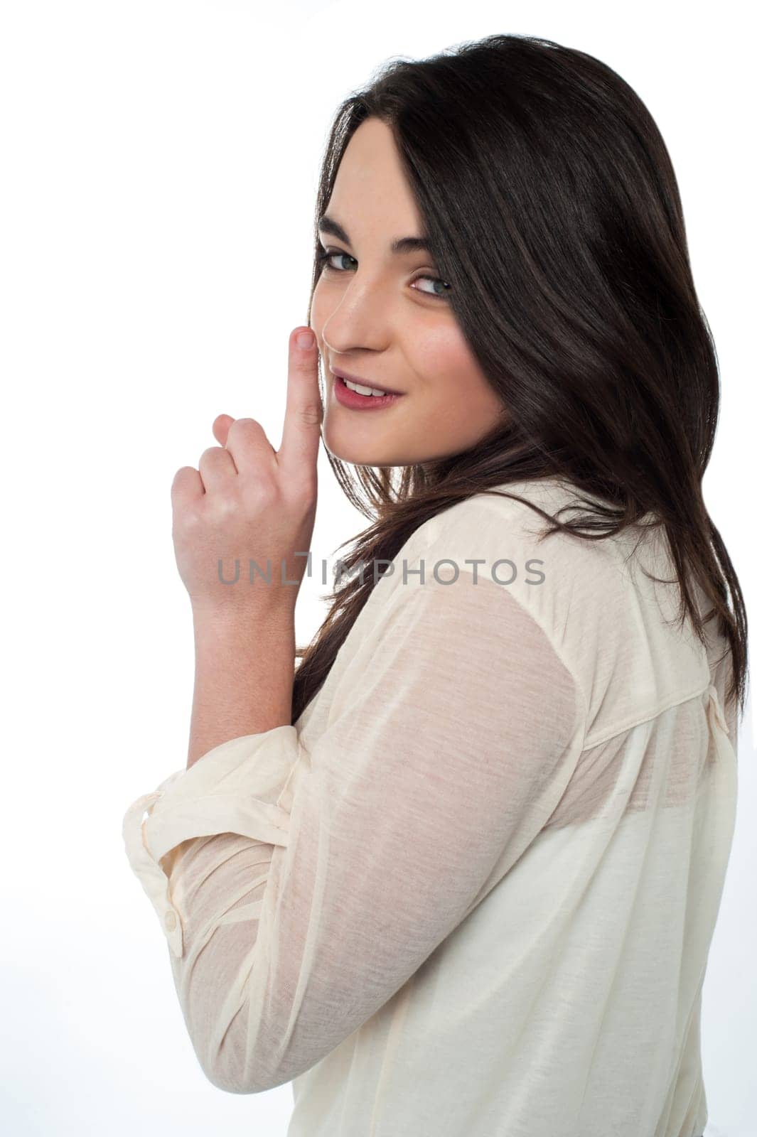 Pretty teenager making silence gesture