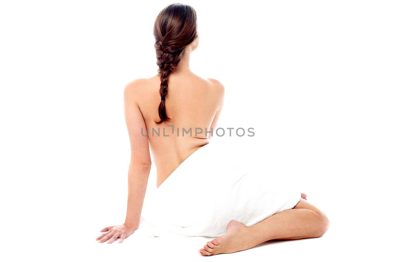 Topless young woman covered with towel