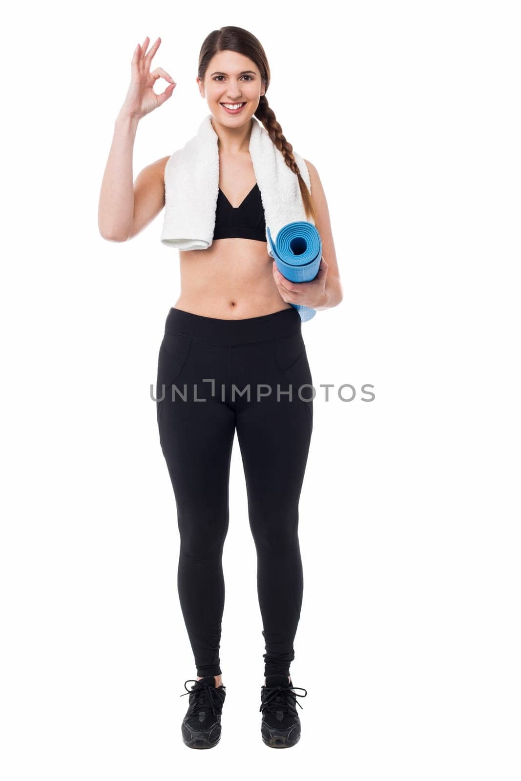 Fit woman holding exercise mat