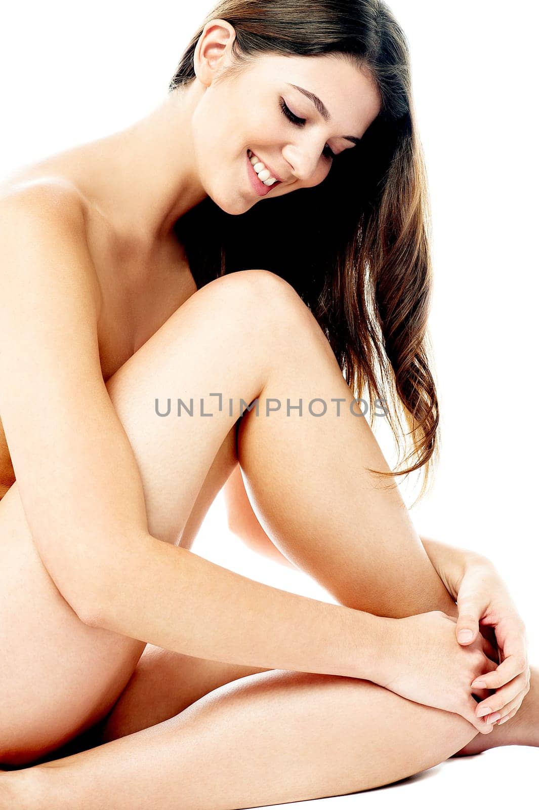 Young nude female model on white