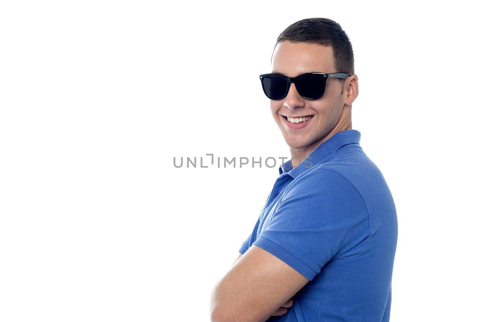 Charming guy in shades, posing sideways.