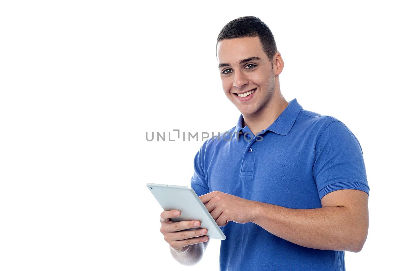 Handsome young guy using his tablet pc
