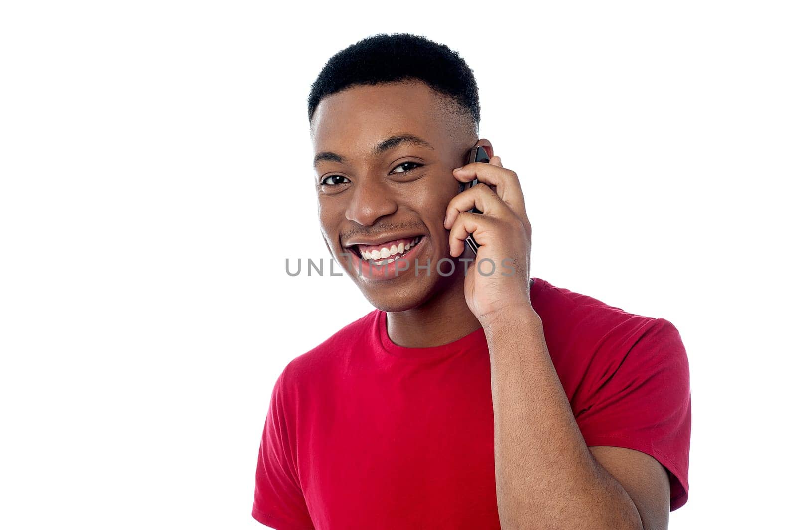 Cheerful boy talking on mobile phone