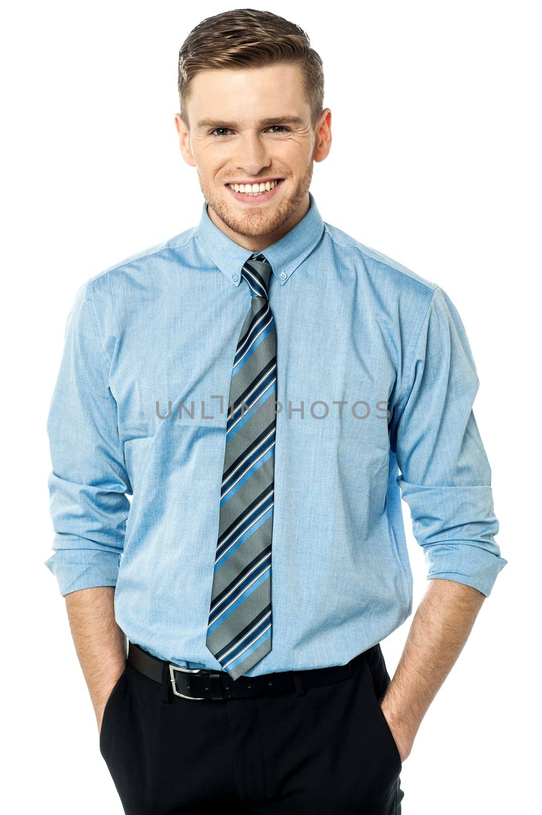 Cheerful businessman with hands in pocket