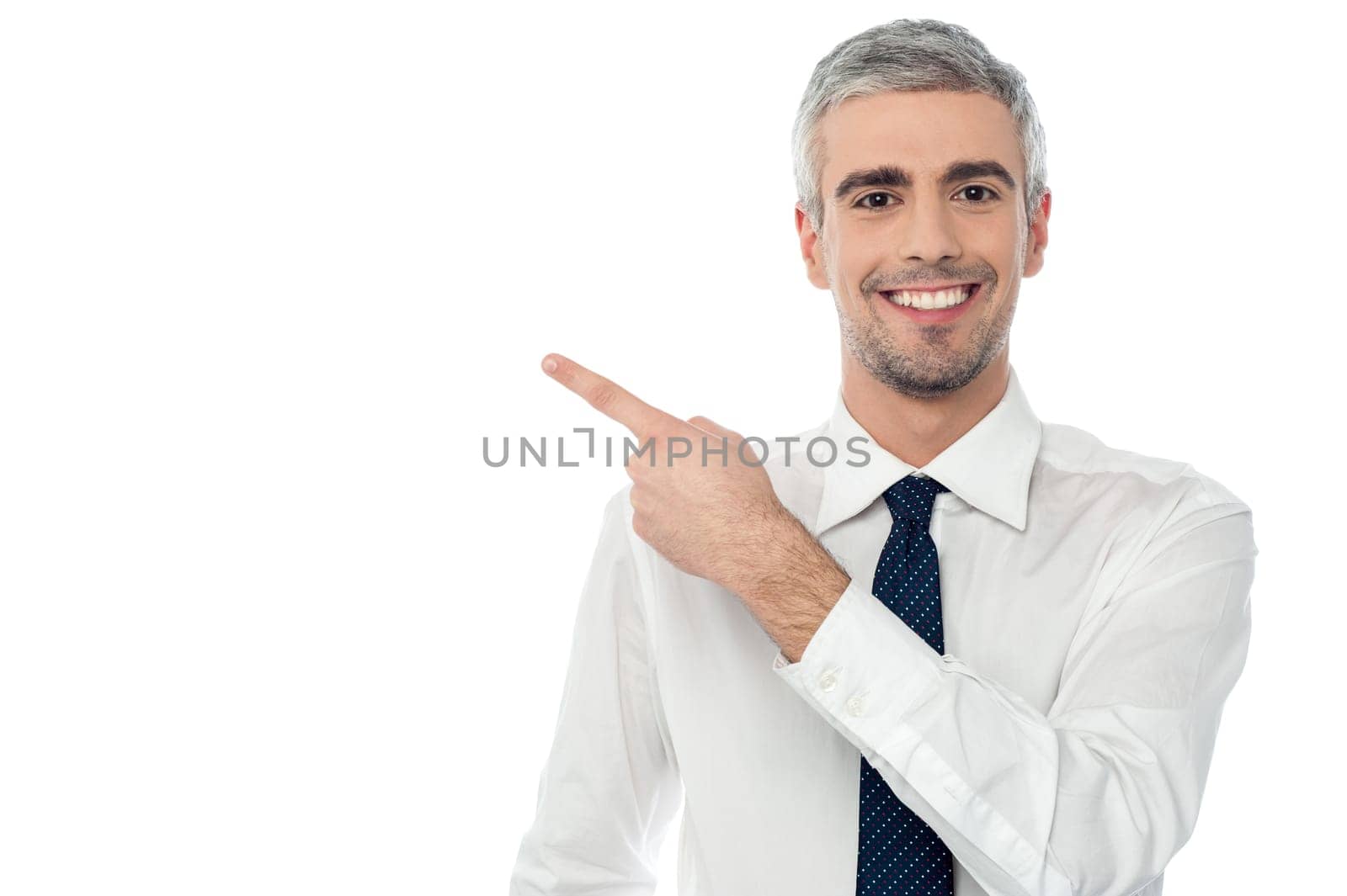 Businessman pointing towards copy space area