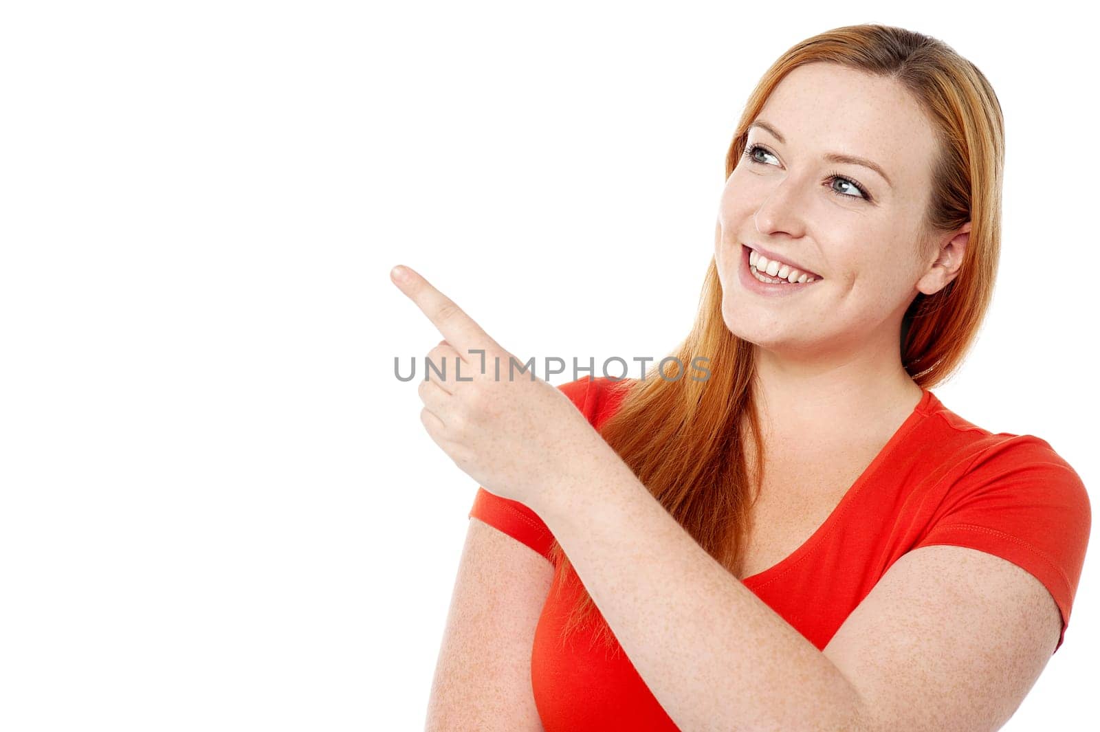 Young lady pointing towards copy space area