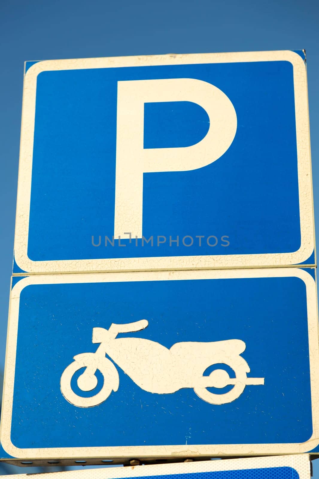 Motorbike Parking Sign with clear blue sky. Swedish.