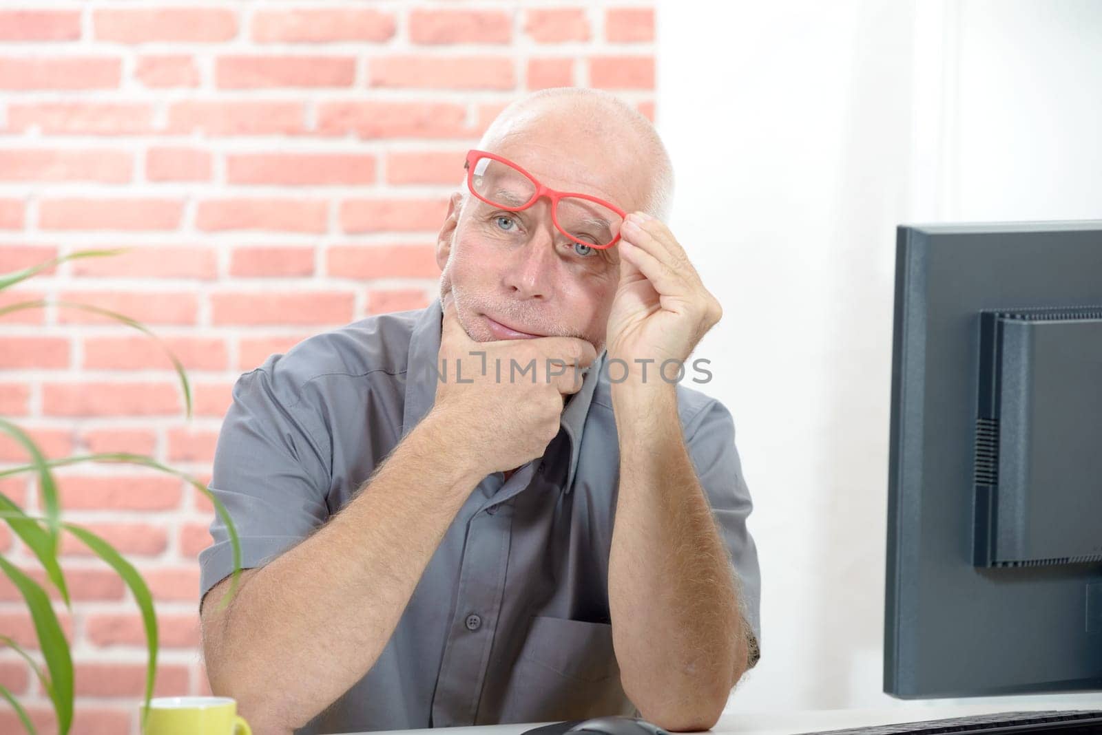 A businessman portrait senior pensive with red glasses