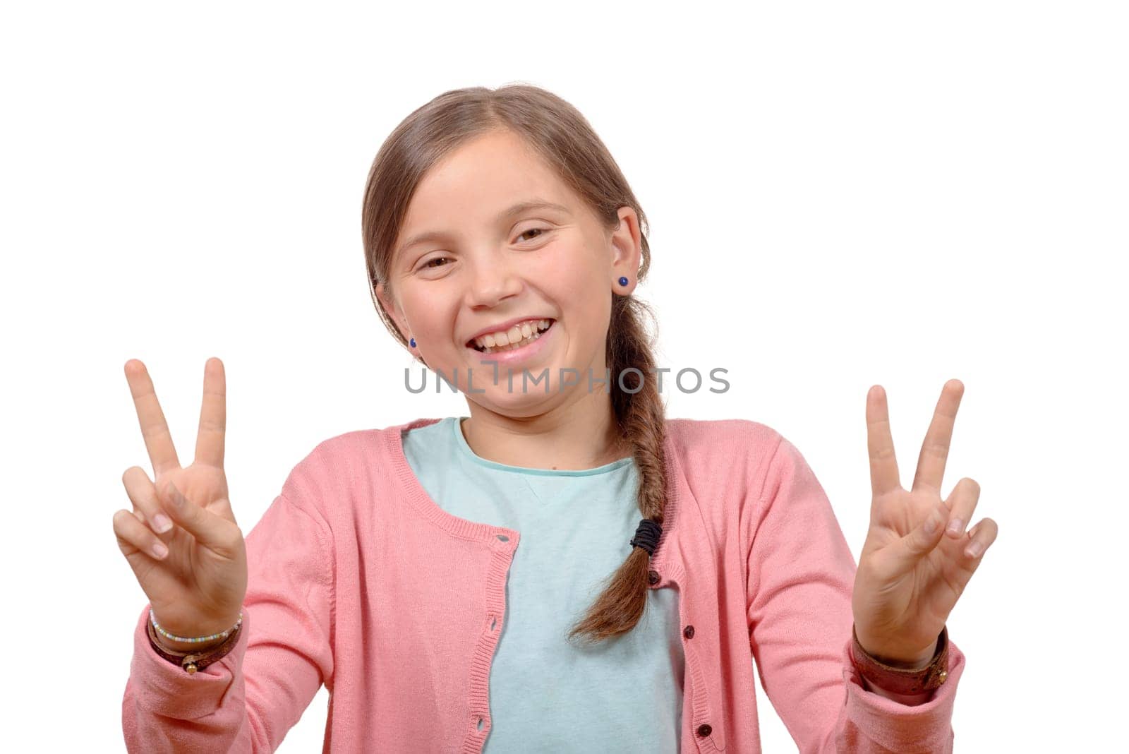 young girl showing her hands by doing victory gesture on white background