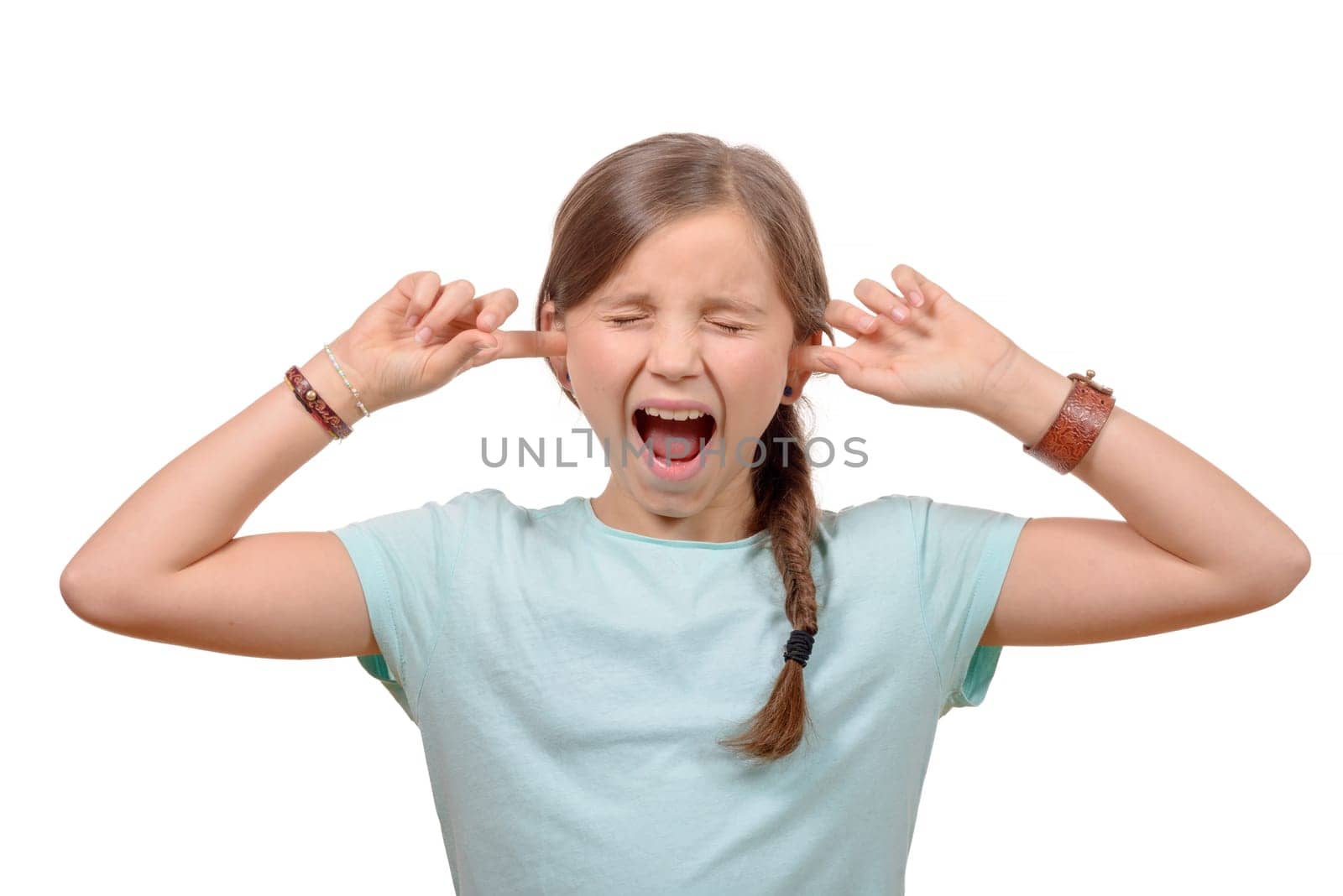 young girl stops his ears with his hands and closes her eyes on white background