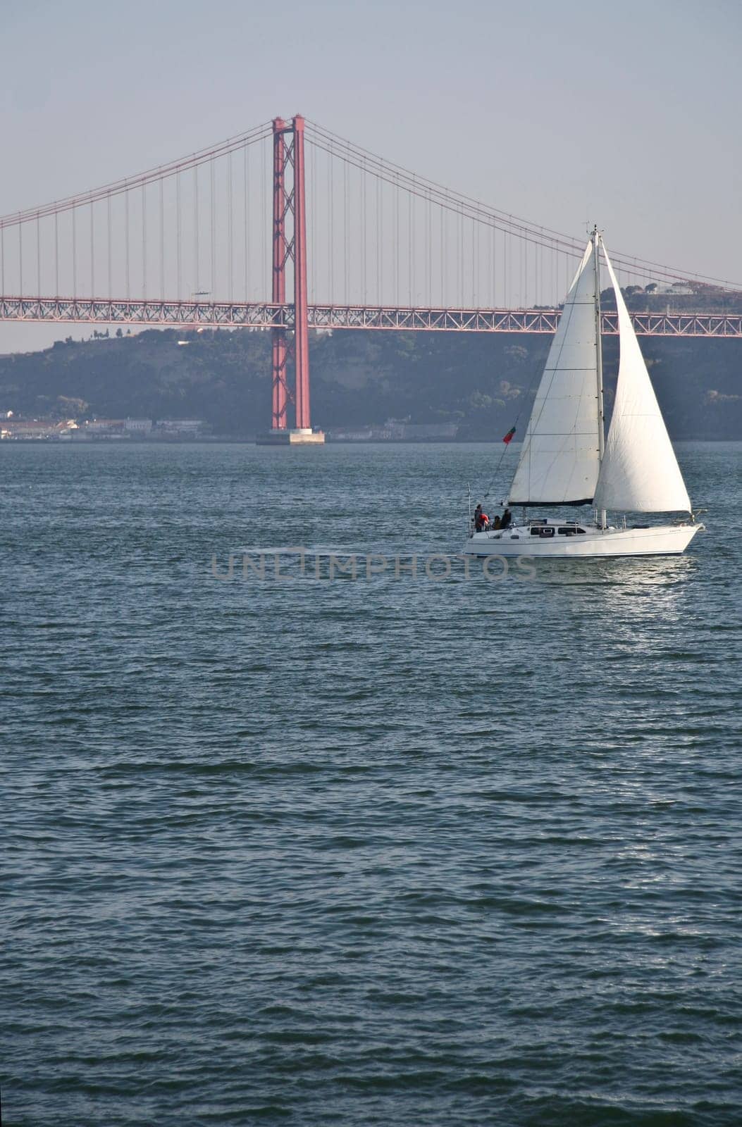 Sailing on the river Tagus with the 25 Abril bridge at the bottom, Lisbon, Portugal
