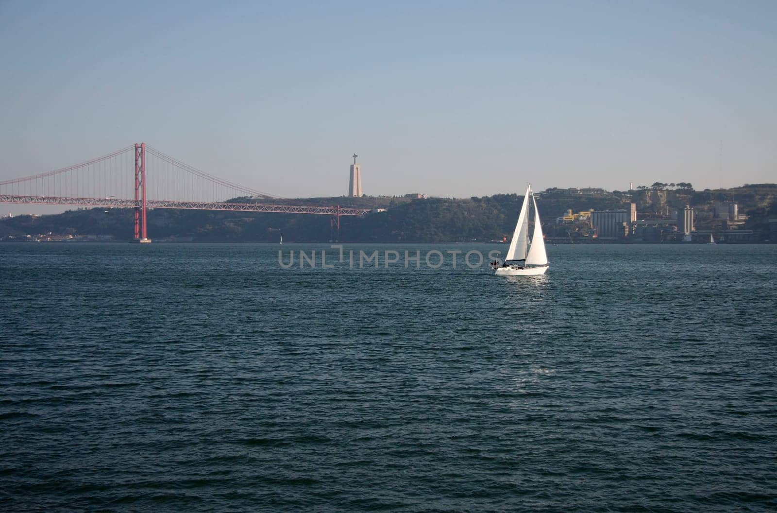 Sailing on the river Tagus with the 25 Abril bridge at the bottom, Lisbon, Portugal