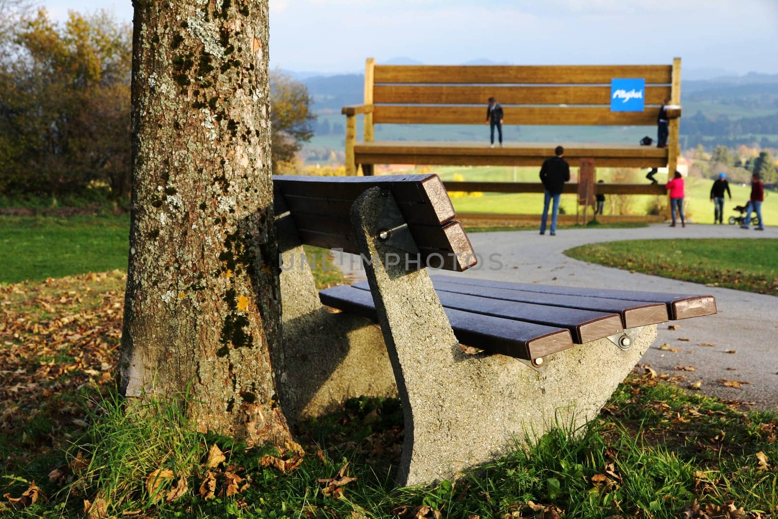 The small and the large bench in the Allgäu. A resting place in front of the large wooden bench - A tourist attraction in the Allgäu