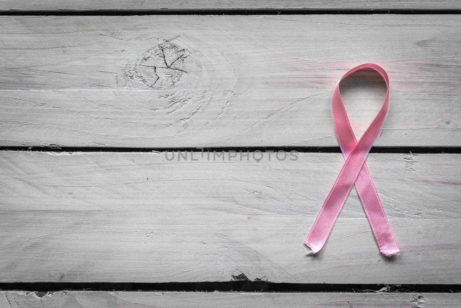 Womens health symbol in pink on wooden background